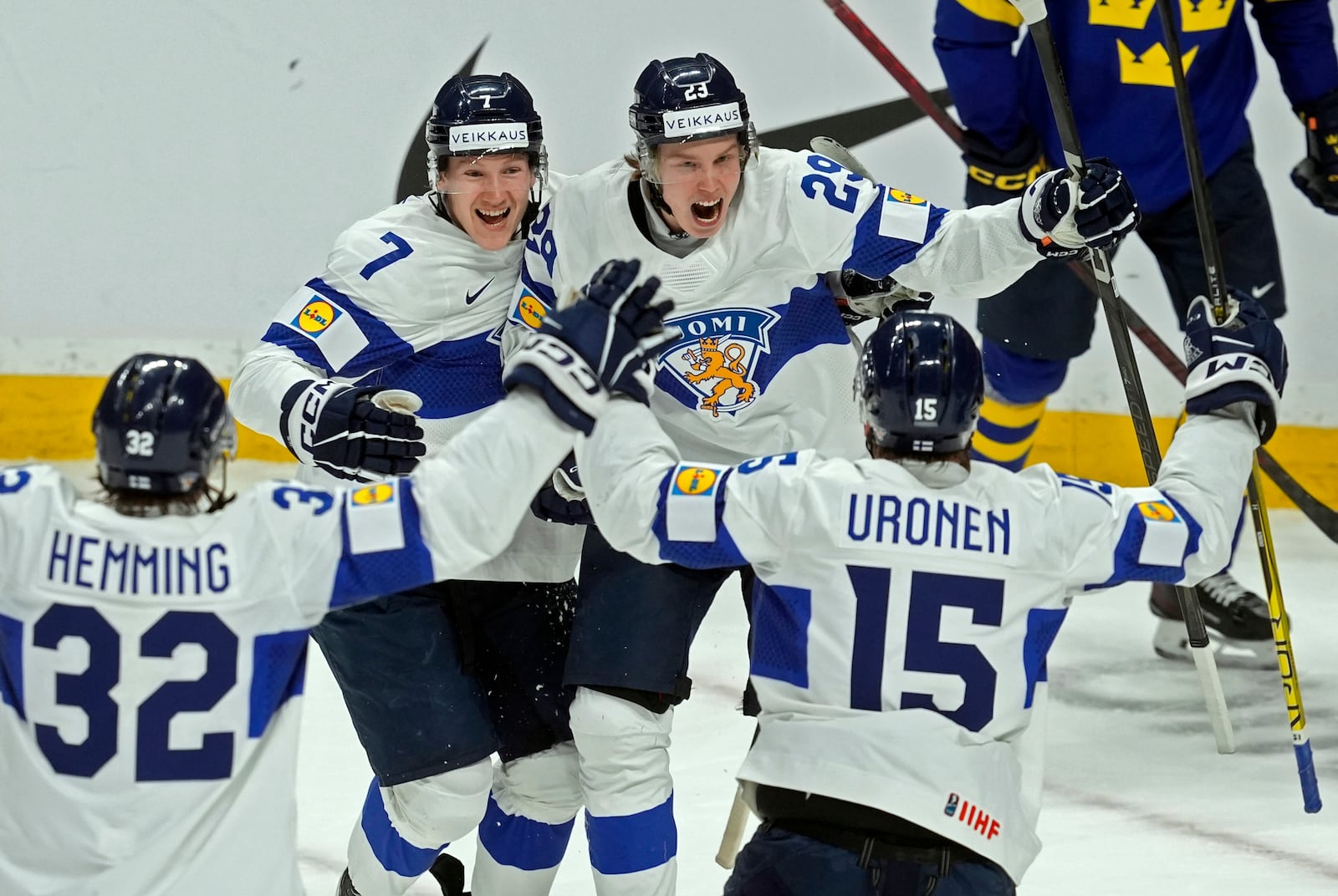 Finland forward Arttu Alasiurua (29) celebrates his goal against Sweden with teammates Emil Hemming (32), Daniel Nieminen (7) and Tuomas Uronen (15) during the second period of a semifinal game at the world junior hockey championship, Saturday, Jan. 4, 2025 in Ottawa, Ontario. (Adrian Wyld/The Canadian Press via AP)