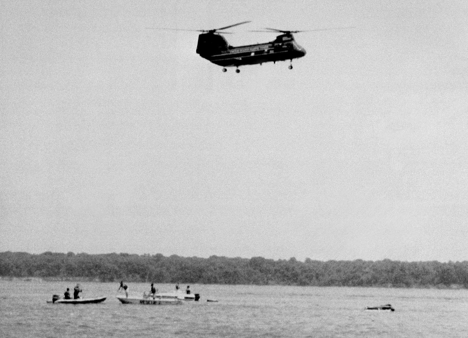 FiLE - Military rescue workers and boaters arrive on the scene of a crash, shortly after it happened, of an experimental V-22 Osprey tilt-rotor aircraft in the Potomac River just off the Quantico Marine Air Station, July 20, 1992, in Quantico, Va. (AP Photo/Bill Kramer)