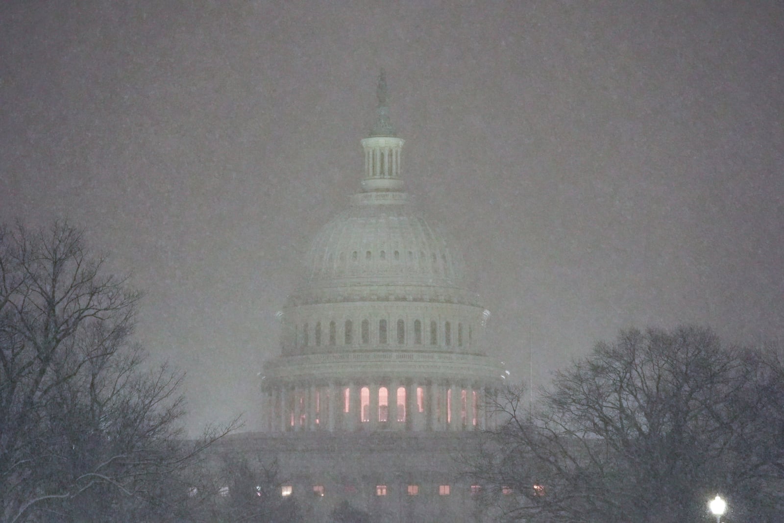 The Capitol is pictured as snow falls ahead of a joint session of Congress to certify the votes from the Electoral College in the presidential election in Washington, Monday, Jan. 6, 2025. (AP Photo/Matt Rourke)