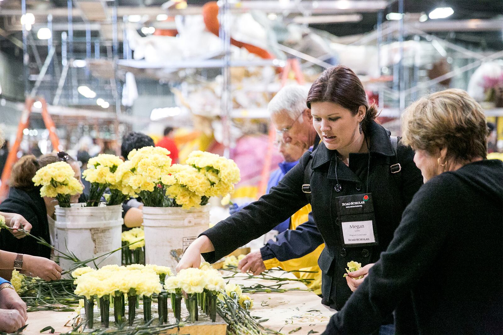 Megan Low, a program coordinator with Road Scholar, shows her tour group how to choose flowers for the Rose parade float they are decorating. Fran Battin took a long awaited trip to Pasadena for the parade in December of 2021.