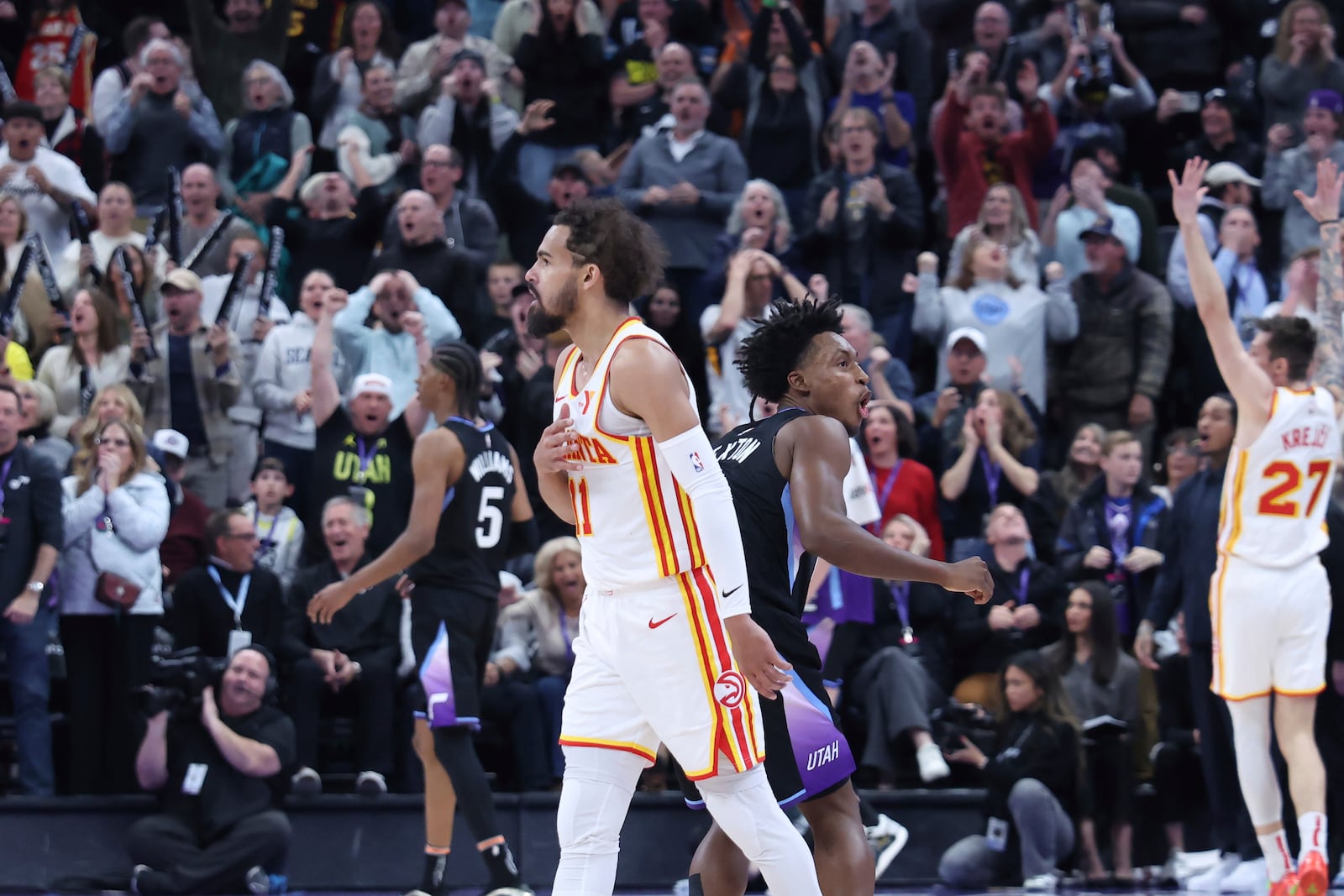 Atlanta Hawks guard Trae Young reacts to a game winning half court shot against the Utah Jazz during an NBA basketball game, Tuesday, Jan. 7, 2025, in Salt Lake City. (AP Photo/Rob Gray)