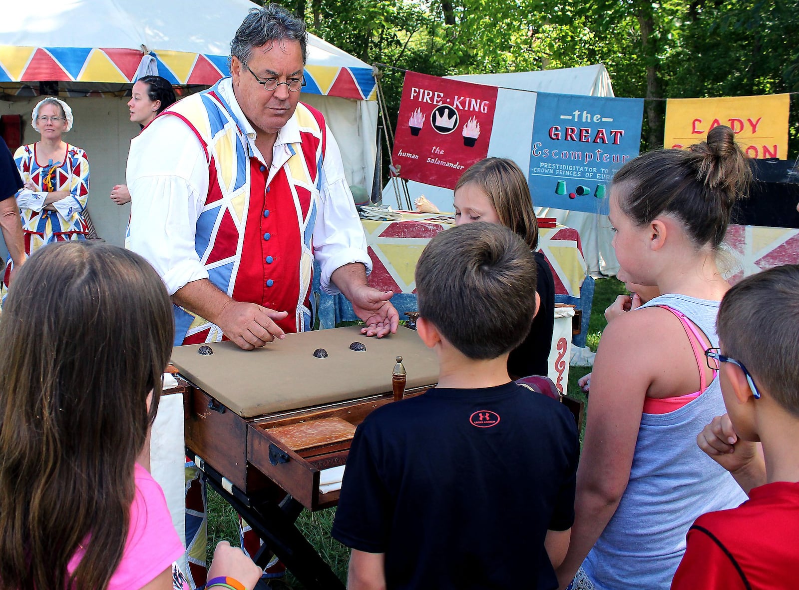 Eric Scites, a performer at The Fair at New Boston demonstrates the “shell and pea” game for fourth grade students from Indian Valley Elementary School. JEFF GUERINI/STAFF