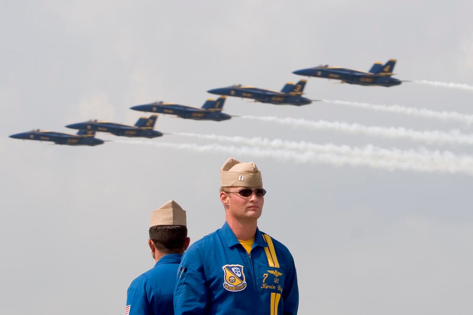 7-29-06--Photo by Ty Greenlees--No. 7 Lt. Kevin "Kojak" Davis, narrator and VIP pilot for the U.S. Navy Blue Angels stands at attention as the team flys in the Dayton Vectren Air Show after he has announced their maneuver.�