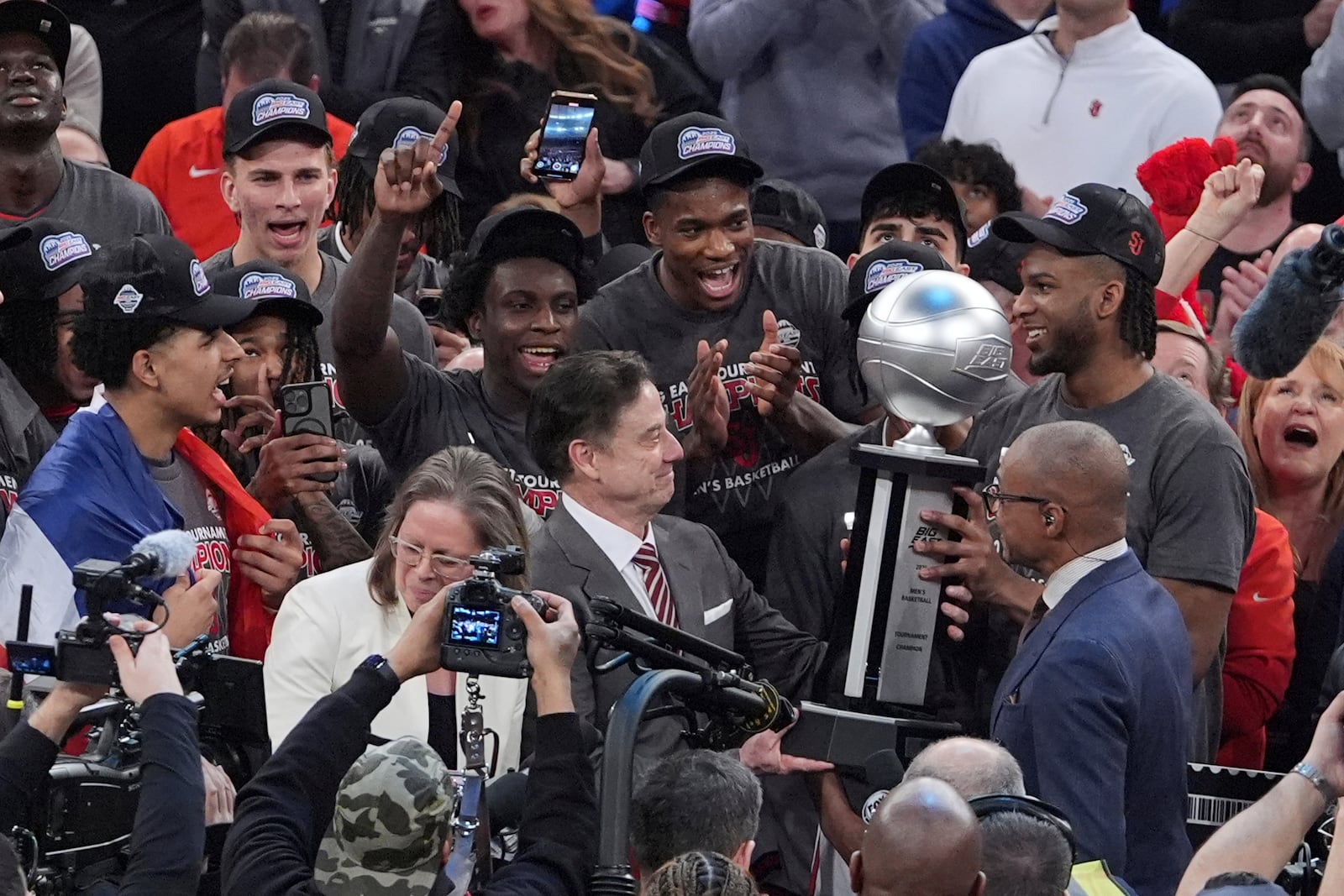 St. John's head coach Rick Pitino admires the tournment trophy after an NCAA college basketball game against Creighton in the championship of the Big East Conference tournament Saturday, March 15, 2025, in New York. (AP Photo/Frank Franklin II)