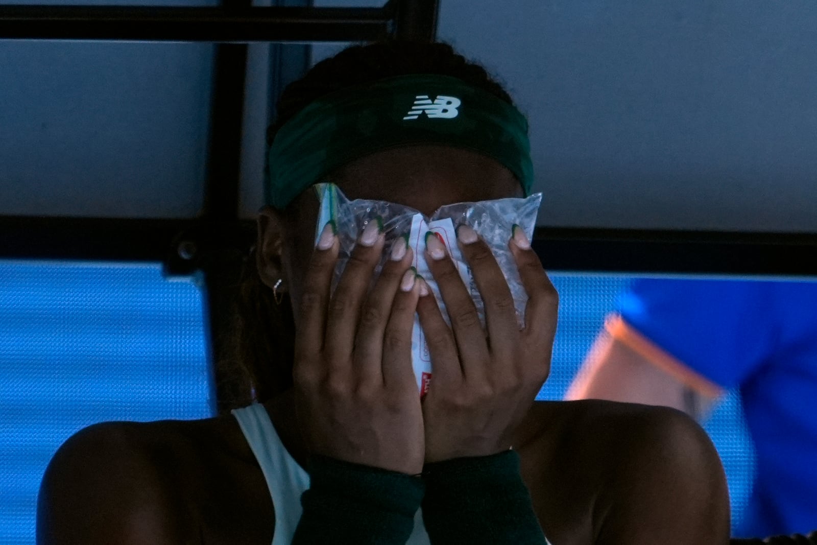 Coco Gauff of the U.S. holds an ice pack to her face during a fourth round match against Belinda Bencic of Switzerland at the Australian Open tennis championship in Melbourne, Australia, Sunday, Jan. 19, 2025. (AP Photo/Asanka Brendon Ratnayake)