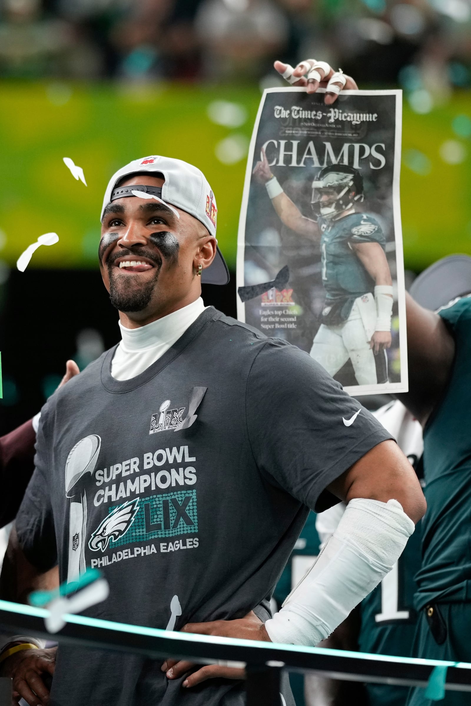 Philadelphia Eagles quarterback Jalen Hurts smiles on the podium after a win over the Kansas City Chiefs during the NFL Super Bowl 59 football game, Sunday, Feb. 9, 2025, in New Orleans. (AP Photo/Matt Slocum)