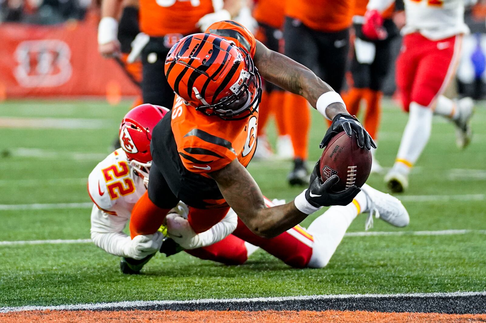 Cincinnati Bengals wide receiver Tee Higgins (85) reaches in for a touchdown as he's tackled by Kansas City Chiefs safety Juan Thornhill (22) in the first half of an NFL football game in Cincinnati, Sunday, Dec. 4, 2022. (AP Photo/Joshua Bickel)