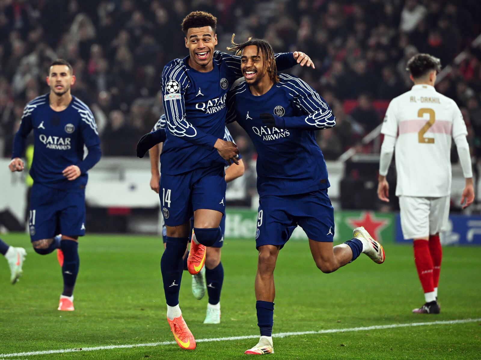 PSG's Bradley Barcola, centre right, celebrates with Desire Doue after scoring the opening goal during the Champions League opening phase soccer match between VfB Stuttgart and Paris Saint-Germain in Stuttgart, Germany, Jan. 29, 2025. (Marijan Murat/dpa via AP)