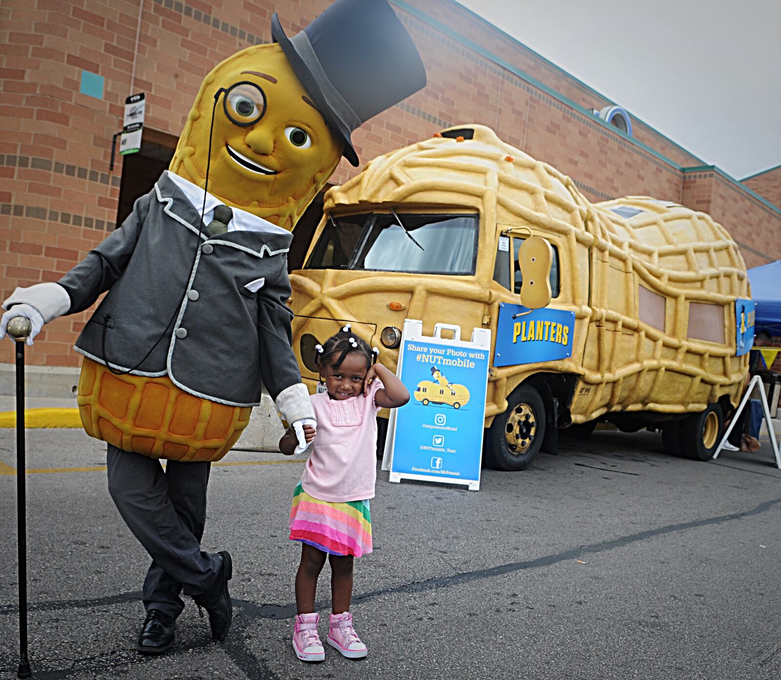 Mr. Peanut and his Nutmoblie posed for pictures with fans, like 4-year-old Jaida Maye, at the Kroger store on Hillcrest Avenue in Dayton on Thursday, Sept. 6, 2018. MARSHALL GORBY / STAFF