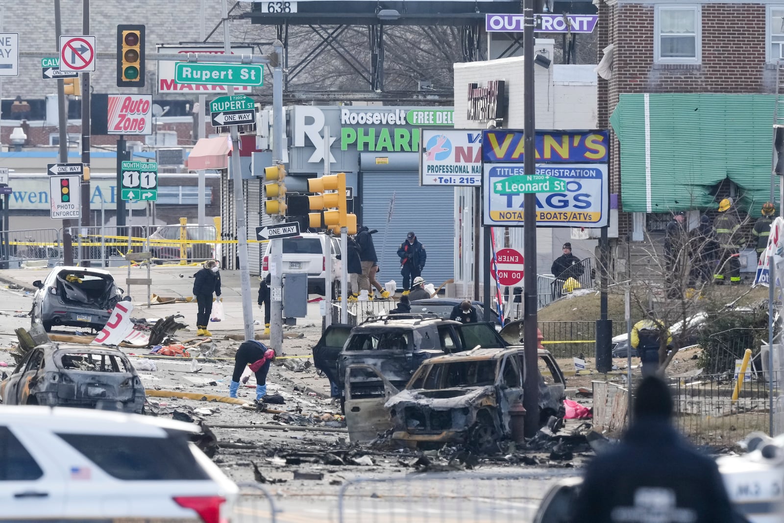 Investigators work the scene after a small plane crashed in Philadelphia, Saturday, Feb. 1, 2025. (AP Photo/Matt Rourke)