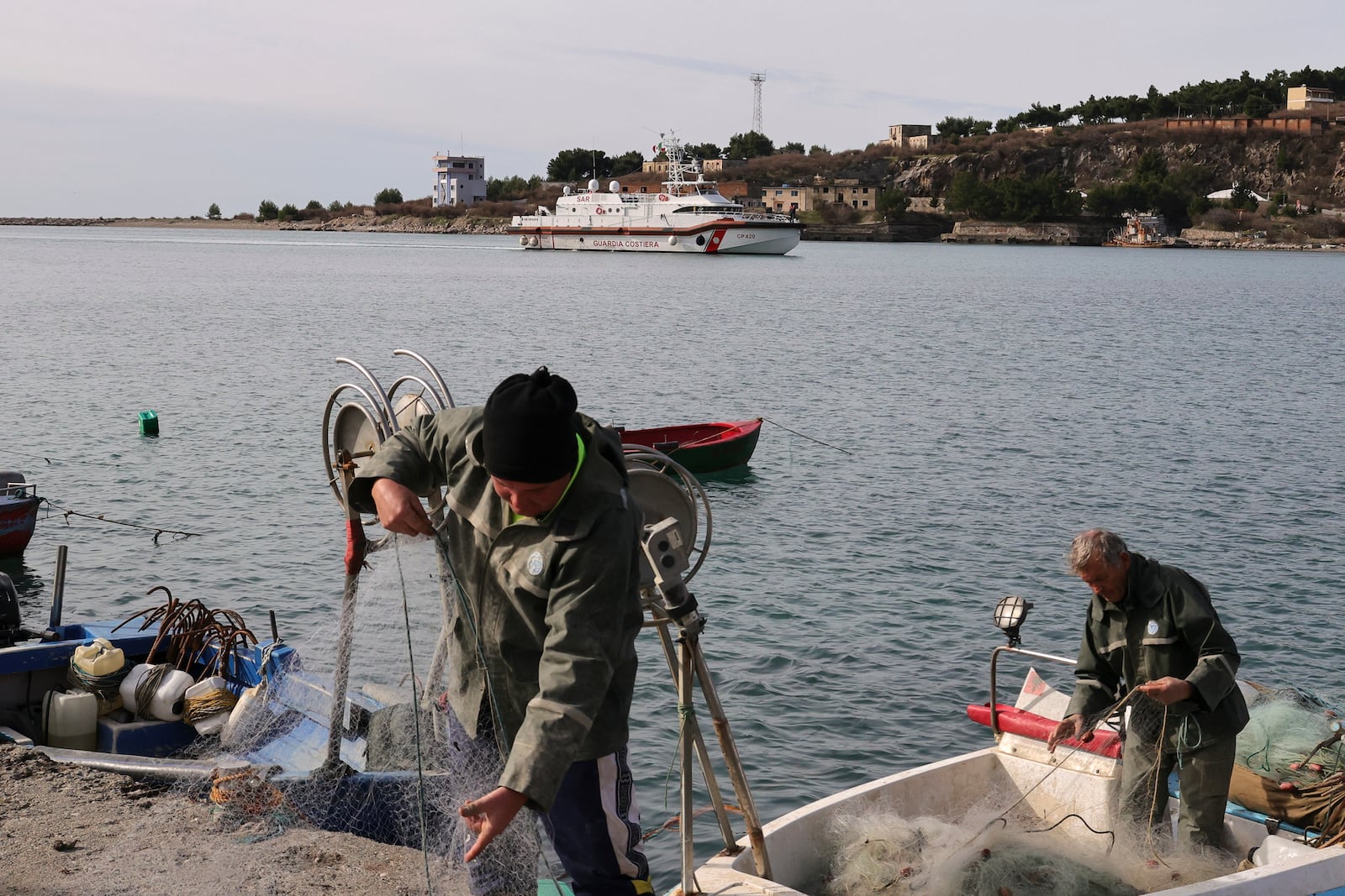 An Italian Coast Guard vessel approaches the port of Shengjin due to transfer migrants from the asylum processing centers in Albania back to Italy, in Shengjin, northwestern Albania, Saturday, Feb. 1, 2025. (AP Photo/Vlasov Sulaj)