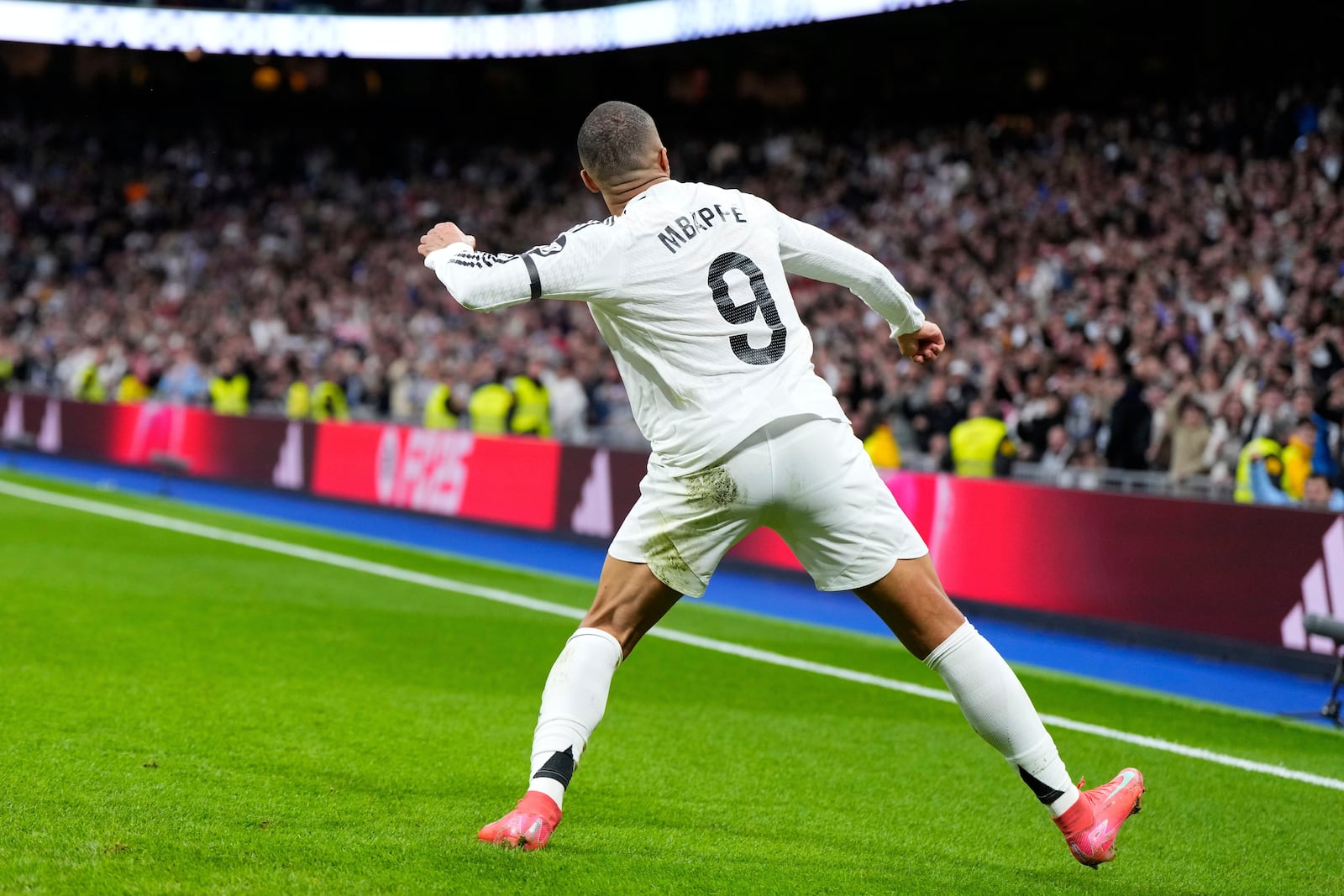 Real Madrid's Kylian Mbappe celebrates after scoring his side's opening goal during the Spanish La Liga soccer match between Real Madrid and Rayo Vallecano at the Santiago Bernabeu stadium in Madrid, Spain, Sunday, March 9, 2025. (AP Photo/Manu Fernandez)