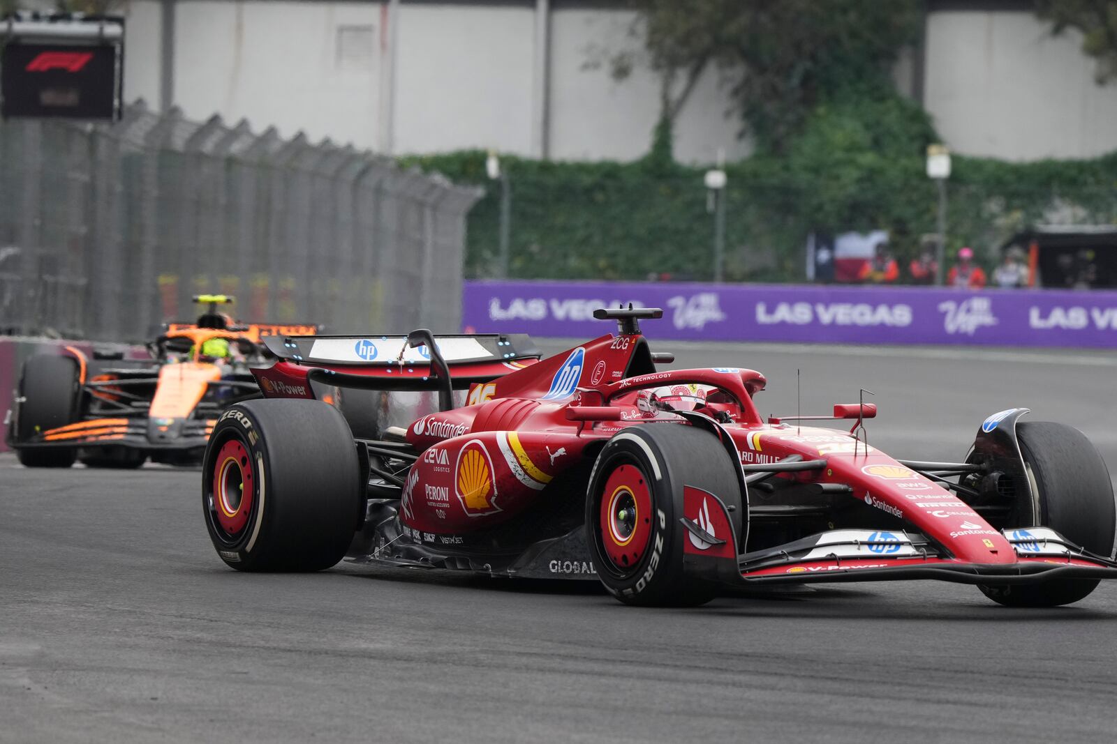 Charles Leclerc, of Monaco, steers his Ferrari followed by McLaren driver Lando Norris of Britain during the Formula One Mexico Grand Prix auto race at the Hermanos Rodriguez racetrack in Mexico City, Sunday, Oct. 27, 2024. (AP Photo/Fernando Llano)