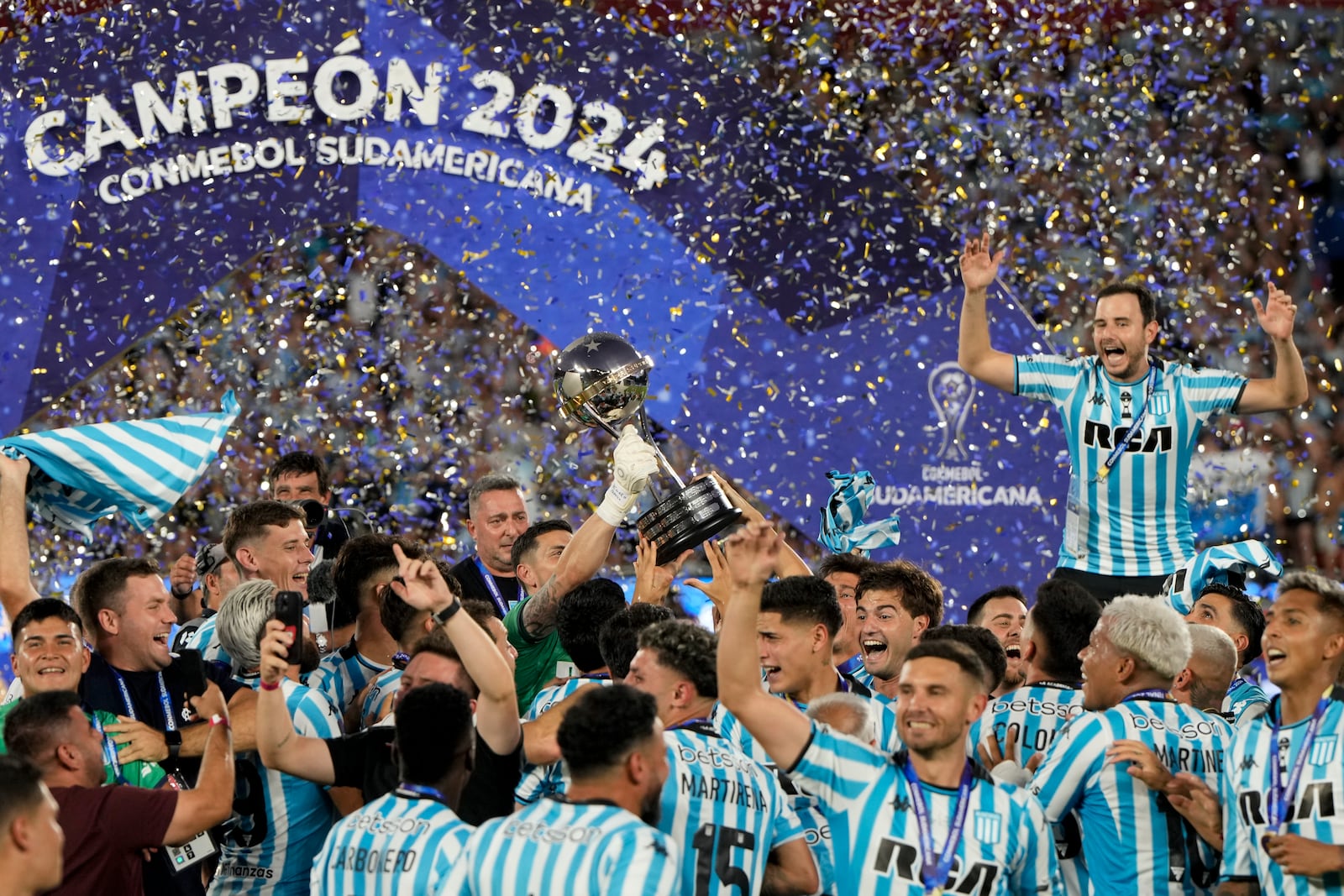 Players of Argentina's Racing Club celebrate with the trophy after winning the Copa Sudamericana final soccer match against Brazil's Cruzeiro in Asuncion, Paraguay, Saturday, Nov. 23, 2024. (AP Photo/Jorge Saenz)