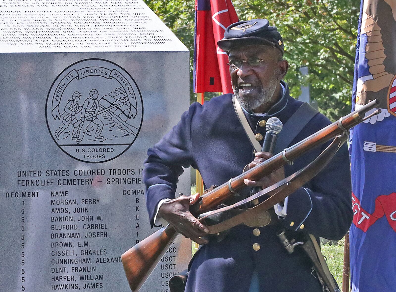 Frederick Smith, a Civil War Historical Interpreterand Presenter, quotes an emotional poem by Paul Laurence Dunbar entitled "The Colored Soldiers" Friday during the dedication of the United States Colored Troops Civil War Monument at Ferncliff Cemetery. BILL LACKEY/STAFF