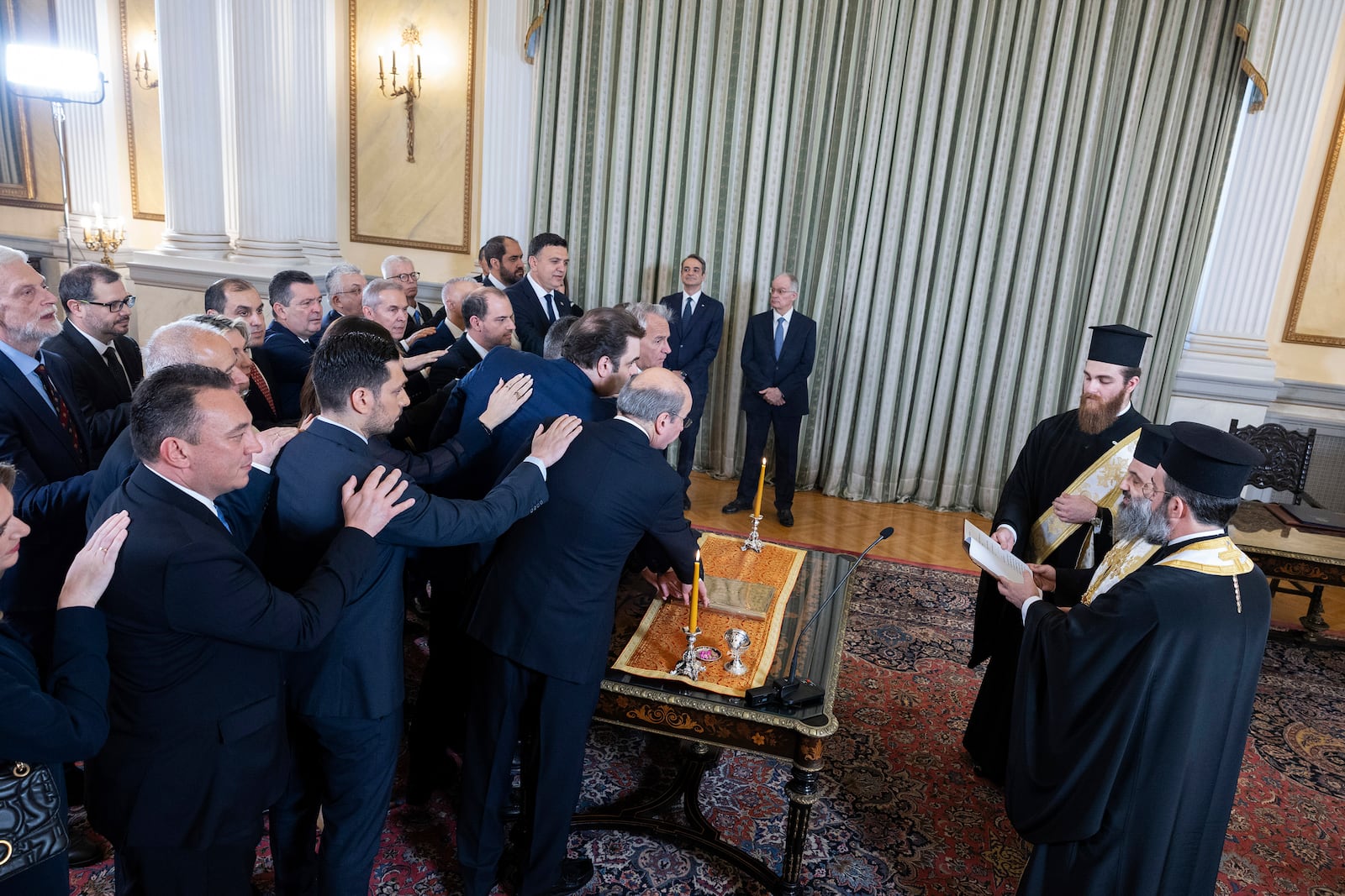 Newly appointed members of Greece's government following a reshuffle, take the oath during a swearing in ceremony at the Presidential palace, in Athens, Greece, Saturday, March 15, 2025. (AP Photo/Yorgos Karahalis)