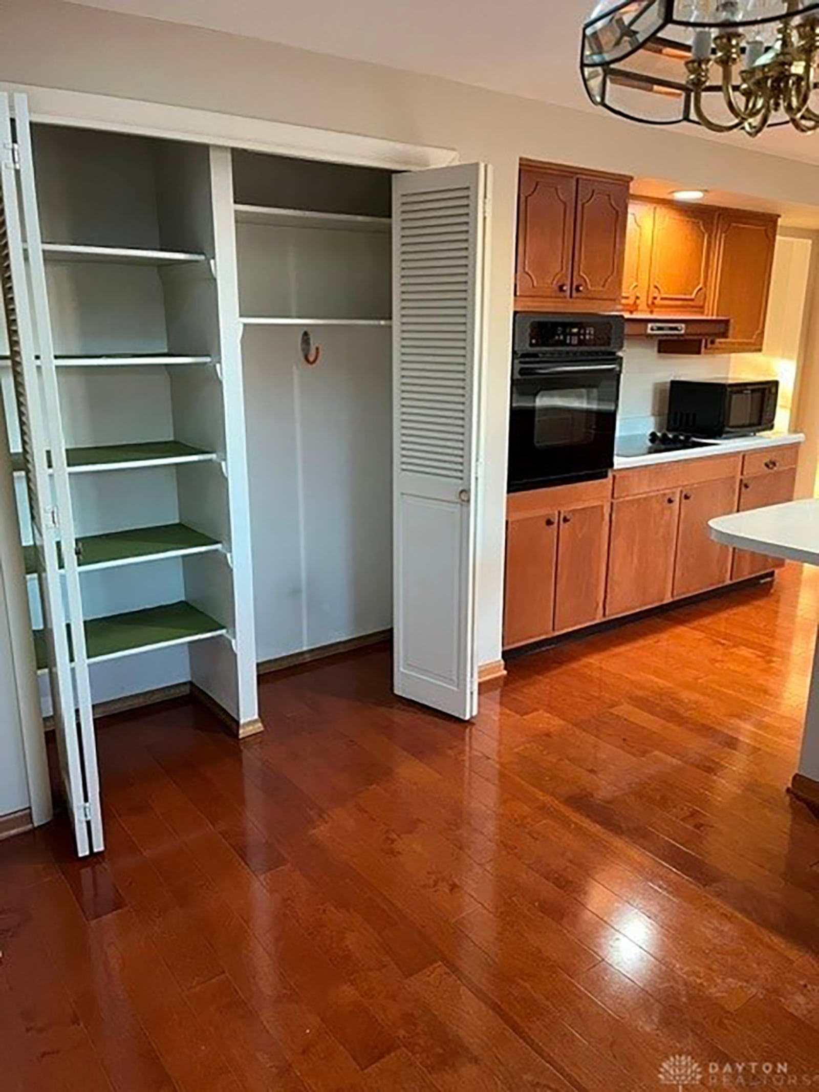 The kitchen features a double pantry with shelving