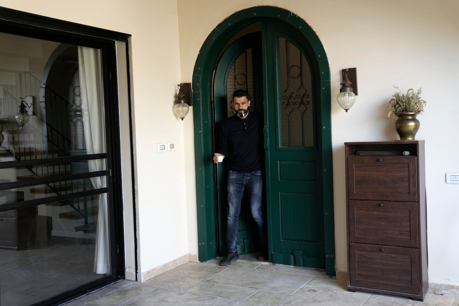 Ahmed Khalefa, a Palestinian citizen of Israel who is charged with incitement to terrorism for demonstrating against the war in Gaza, is seen at home in Umm al-Fahm, Israel, Wednesday, Nov. 20, 2024. (AP Photo/Mahmoud Illean)