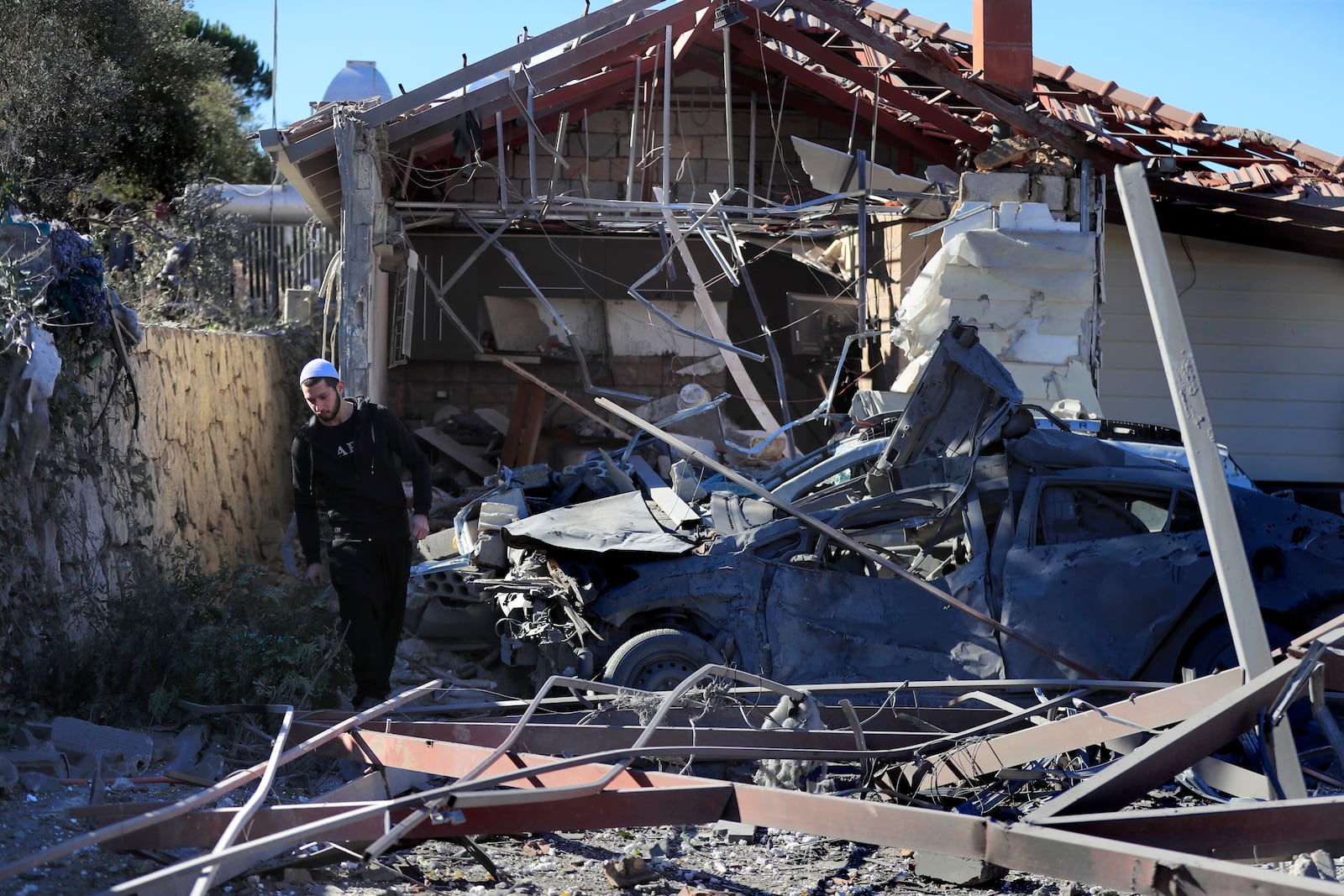 A Druze man walks by the site where an Israeli airstrike hit a compound housing journalists, killing three media staffers from two different news agencies according to Lebanon's state-run National News Agency, in Hasbaya village, southeast Lebanon, Friday, Oct. 25, 2024. (AP Photo/Mohammed Zaatari)