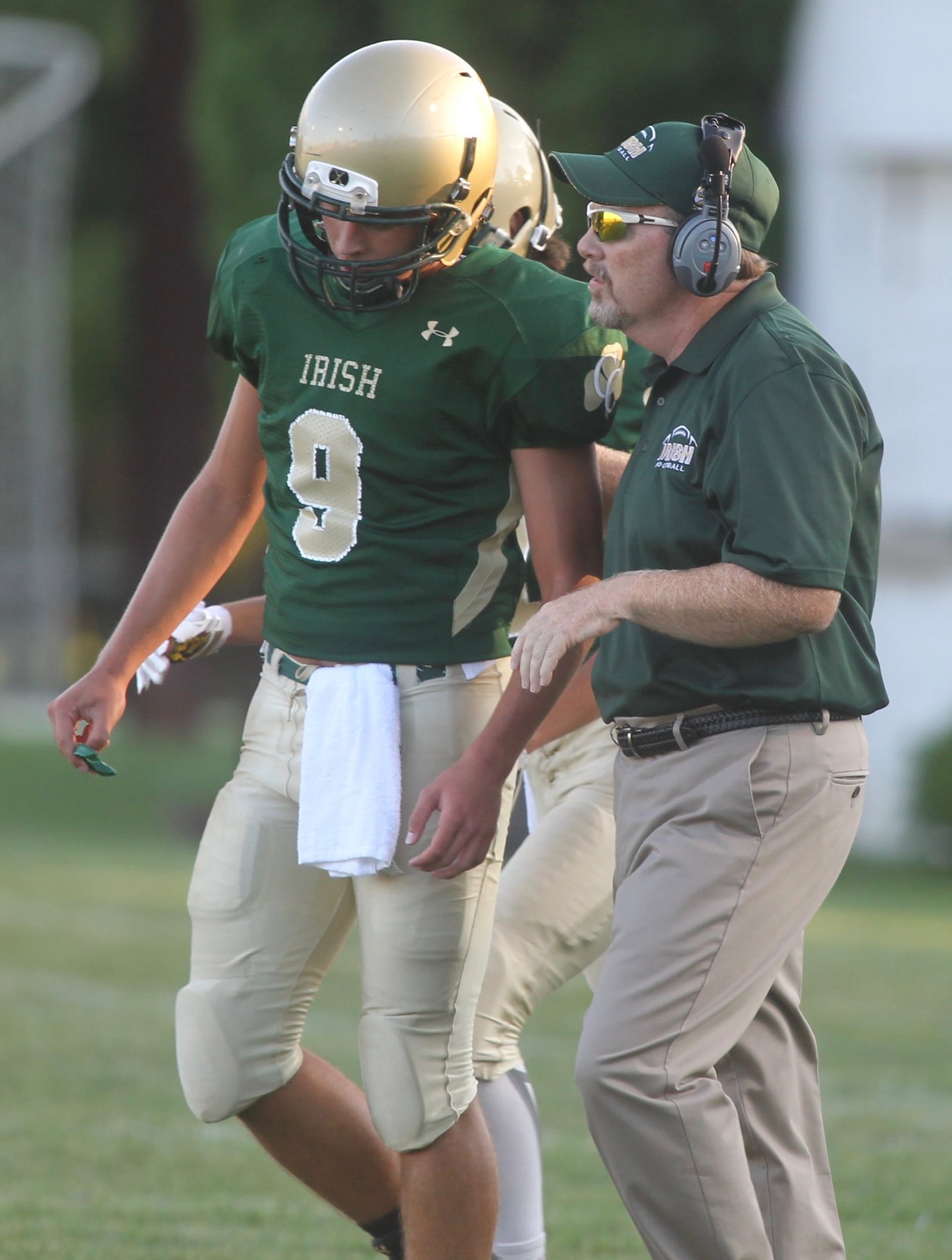 Catholic Central coach Mike McKenna, right, talks to Dominic DeWitt during a game against Graham on Friday, Sept. 2, 2016, at Hallinean Field in Springfield. David Jablonski/Staff