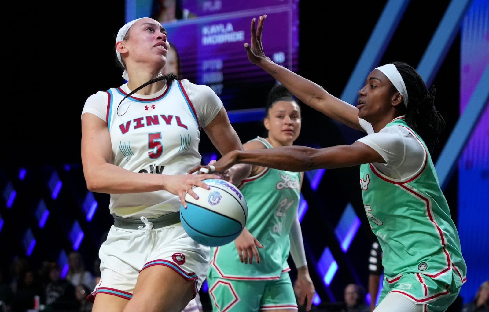 Vinyl forward Dearica Hamby (5) goes to the basket as Laces guard Tiffany Hayes, right, defends during the second half of an Unrivaled 3-on-3 basketball game Friday, Jan. 24, 2025, in Medley, Fla. (AP Photo/Lynne Sladky)