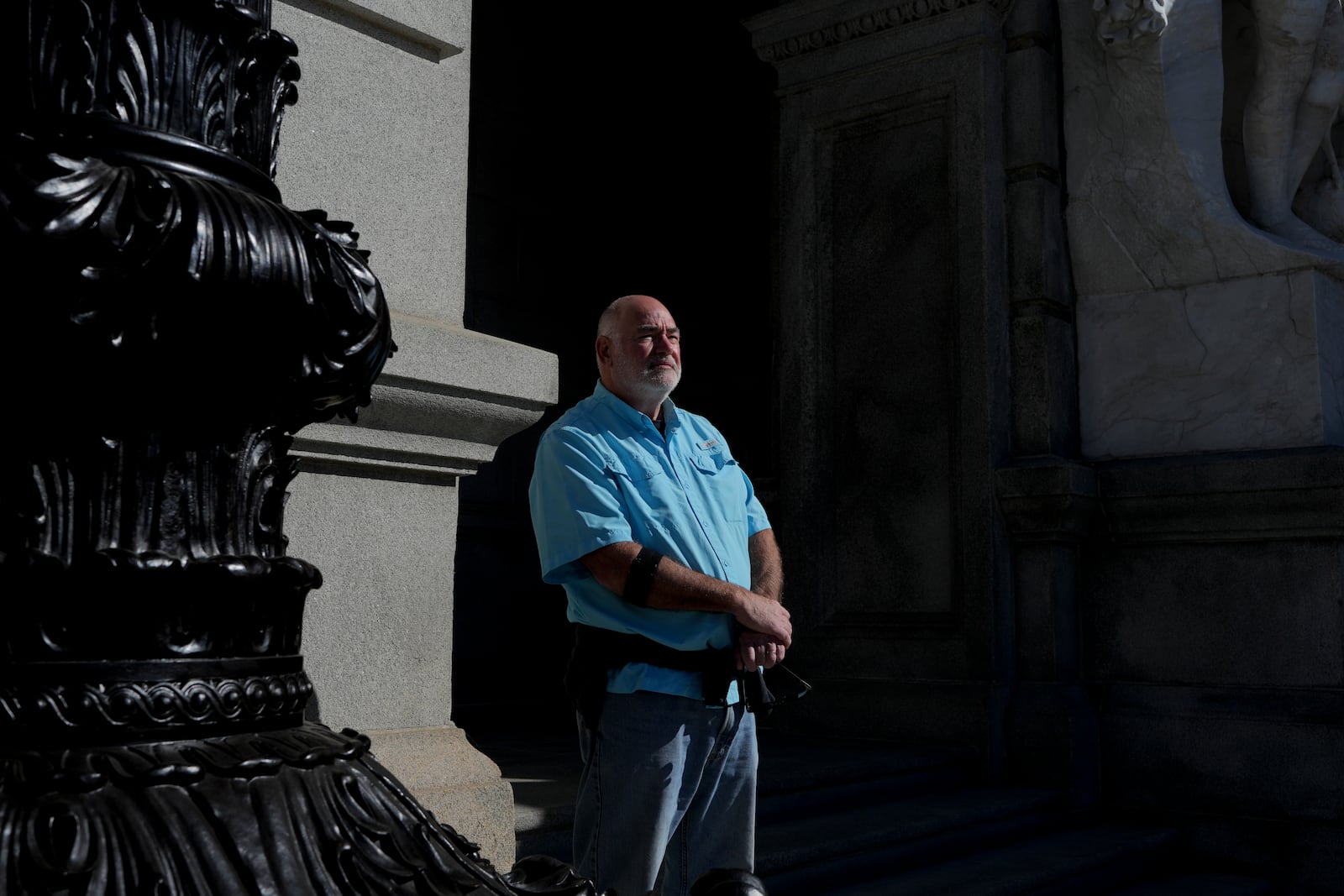 Scott Bassett, a Pennsylvania-born retired teacher who lives in California, stands for a portrait after a visit to the Pennsylvania Capitol in Harrisburg, Pa., on Sunday, Oct. 27, 2024. (AP Photo/Luis Andres Henao)