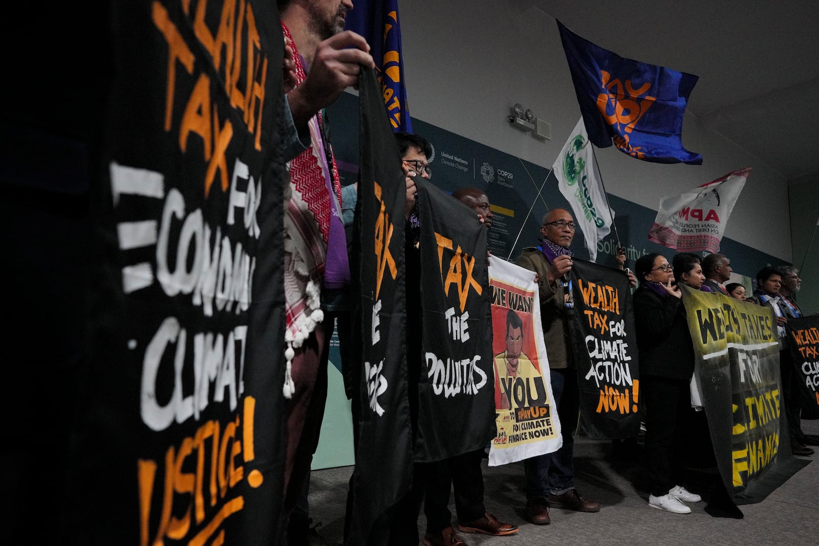 Activists participate in a demonstration for climate finance at the COP29 U.N. Climate Summit, Monday, Nov. 18, 2024, in Baku, Azerbaijan. (AP Photo/Peter Dejong)