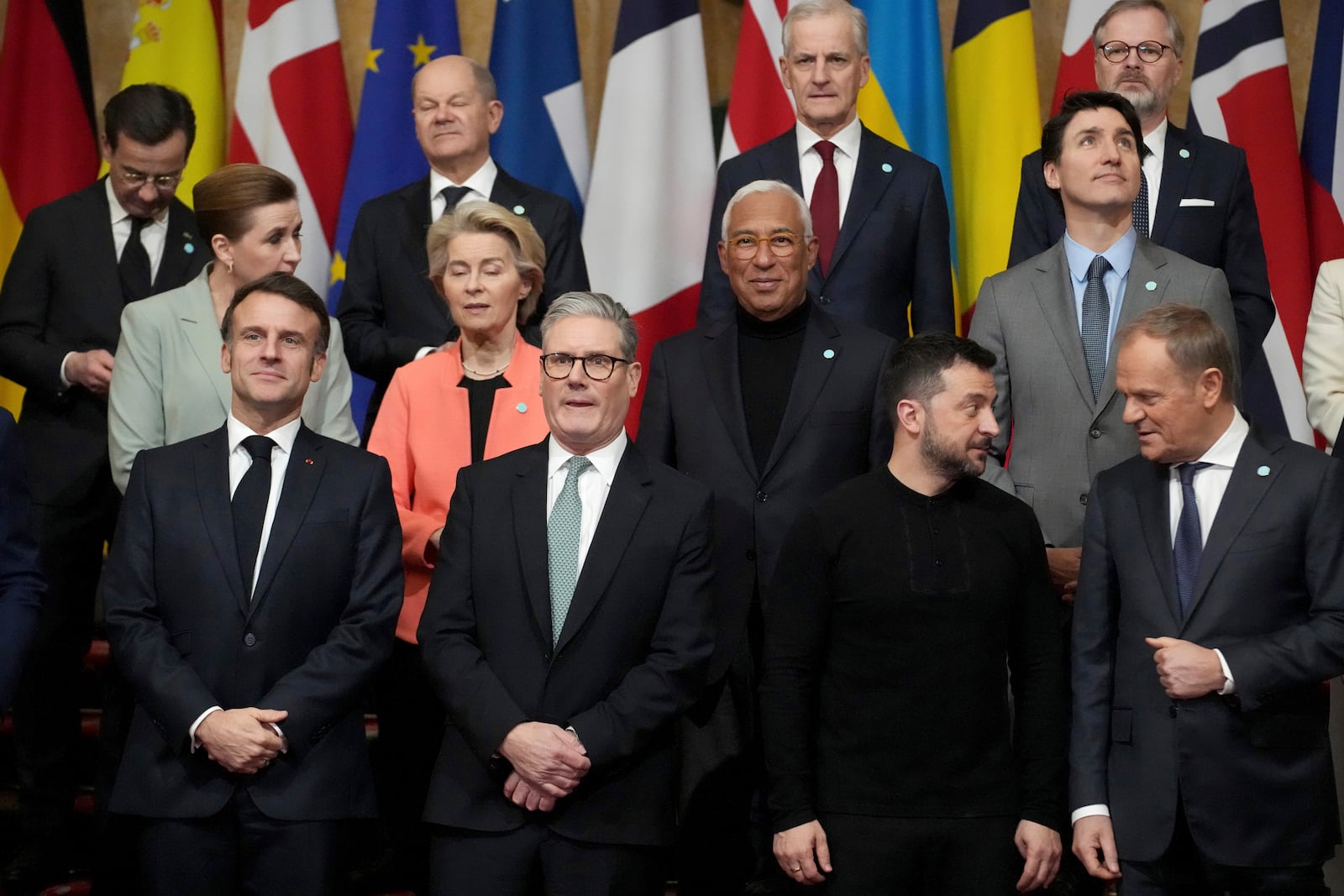 Front row left to right, French President Emmanuel Macron, Britain's Prime Minister Keir Starmer, Ukraine's President Volodymyr Zelenskyy and Poland's Prime Minister Donald Tusk stand with other leaders during a group photo at a summit on Ukraine at Lancaster House in London, Sunday, March 2, 2025. (AP Photo/Christophe Ena, Pool)