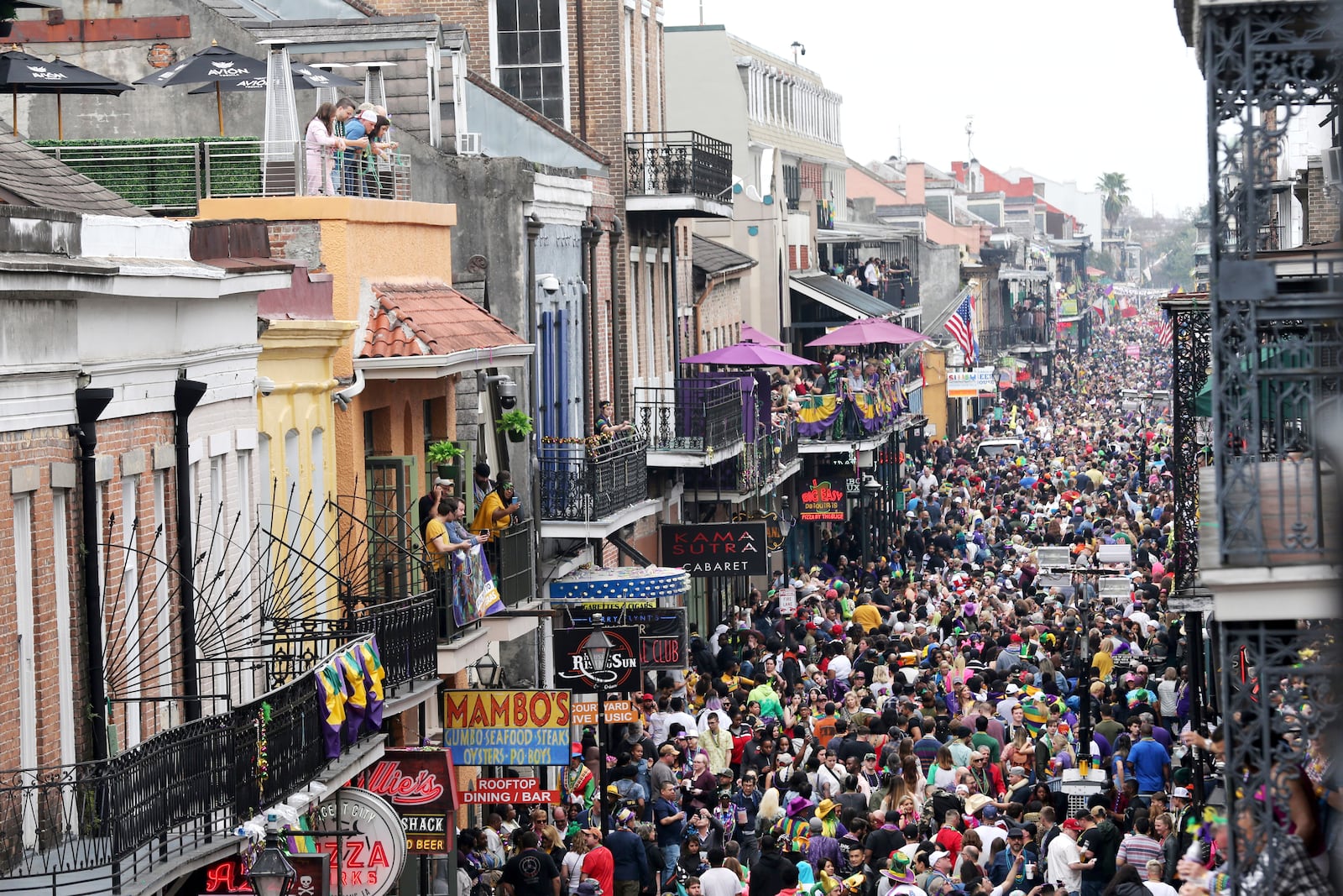 FILE - Revelers fill Bourbon Street on Mardi Gras day in New Orleans, Feb. 25, 2020. (AP Photo/Rusty Costanza, File)