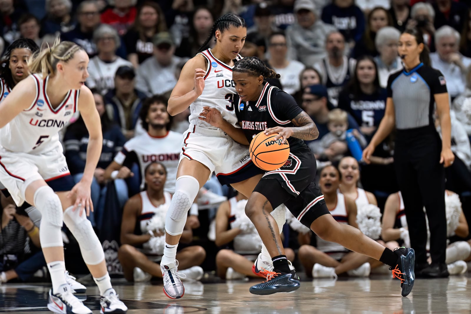 Arkansas State guard Crislyn Rose, right, is guarded by UConn guard Azzi Fudd during the first half in the first round of the NCAA college basketball tournament, Saturday, March 22, 2025, in Storrs, Conn. (AP Photo/Jessica Hill)