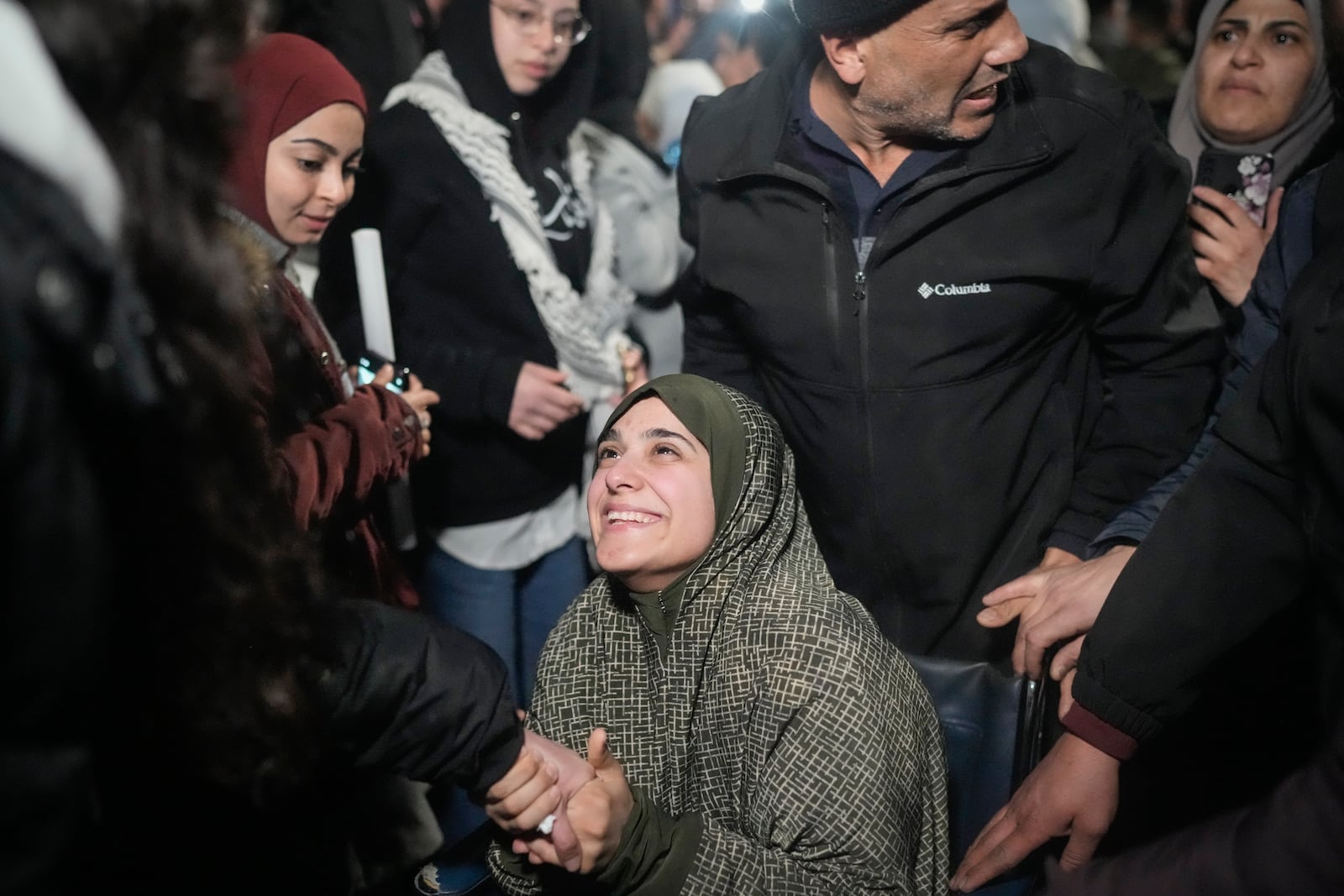 FILE - A female Palestinian prisoner in a wheelchair is greeted following her release from an Israeli prison, in the West Bank city of Beitunia, early Monday, Jan. 20, 2025. (AP Photo/Leo Correa, File)