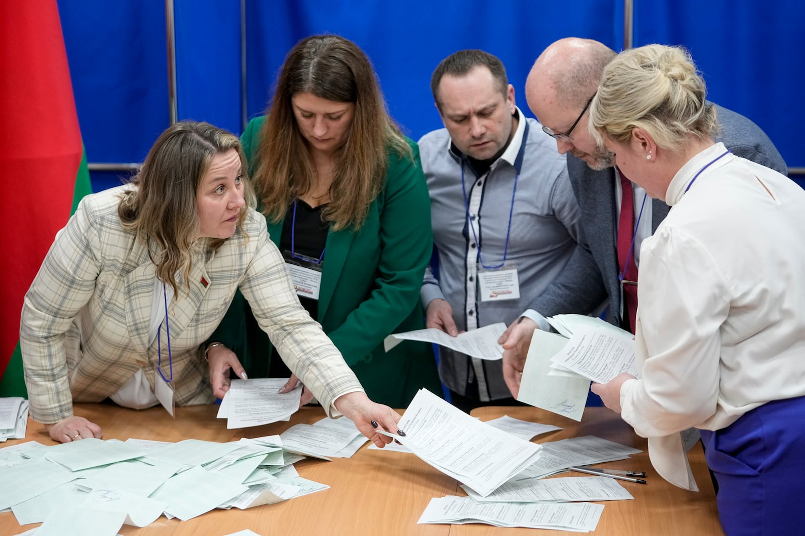 Election commission members count ballots after voting for presidential election at a polling station in Minsk, Belarus, Sunday, Jan. 26, 2025. (AP Photo/Pavel Bednyakov)