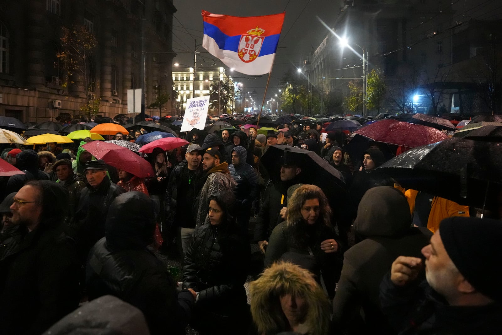 People march during a protest following collapse of a concrete canopy at the railway station in Novi Sad that killed 14 people, in Belgrade, Serbia, Monday, Nov. 11, 2024. (AP Photo/Darko Vojinovic)