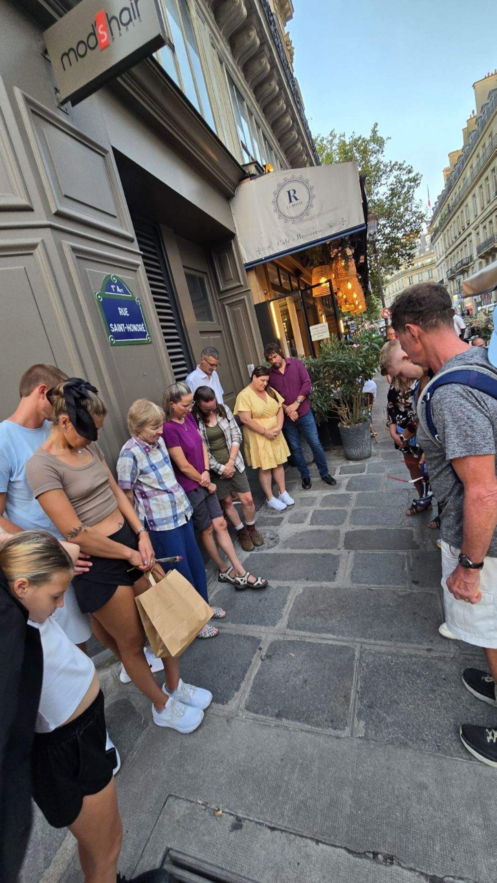 Family and friends of Grace Norman had a group prayer for her Sunday night outside a Paris restaurant. CONTRIBUTED