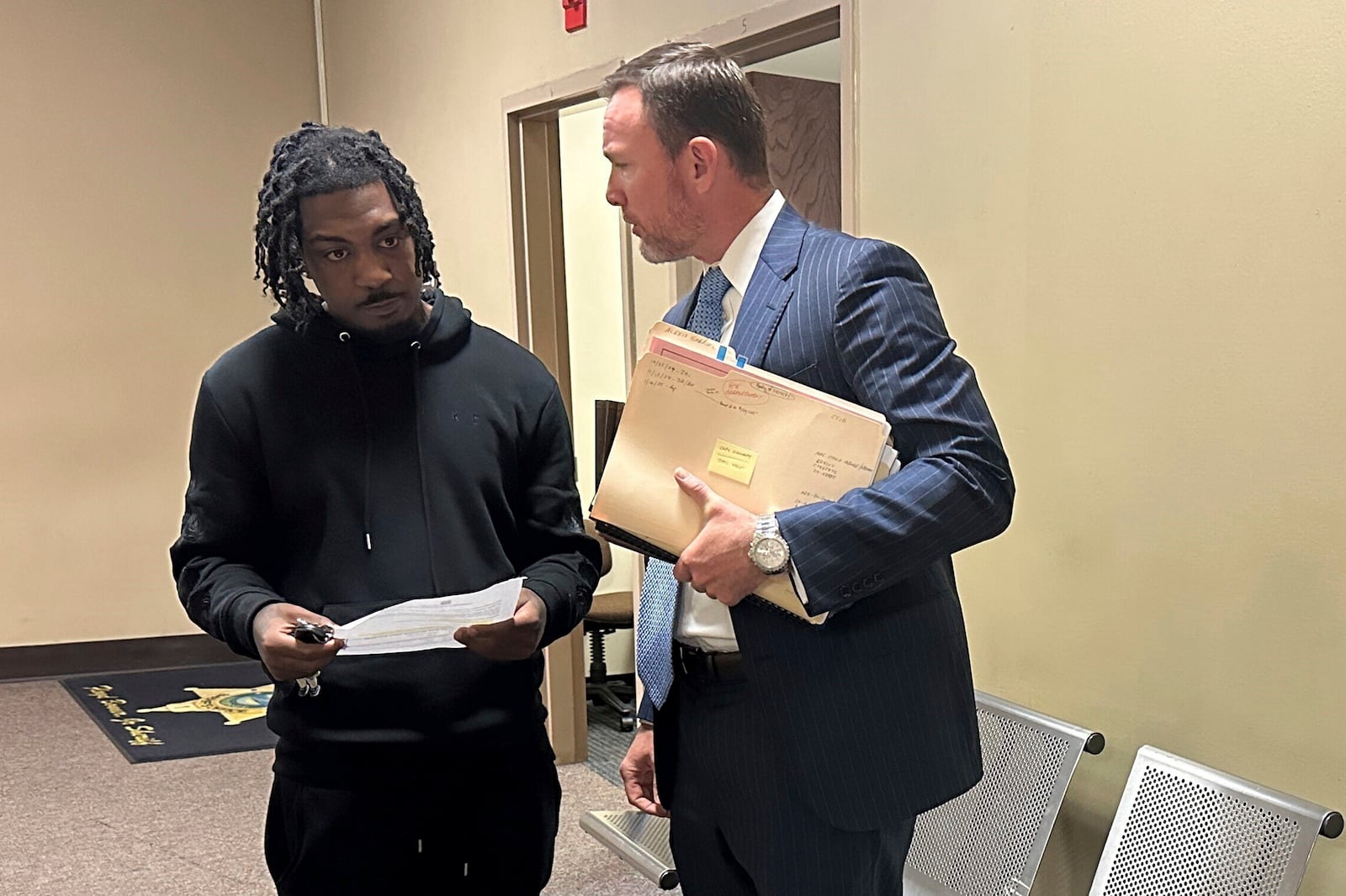 Jermarcus Johnson, left, speaks with his lawyer Josh Corman after Johnson was sentenced to probation for his role after the 2021 fatal shooting of Young Dolph on Friday, Nov. 22, 2024, in Memphis, Tenn. (AP Photo/Adrian Sainz).