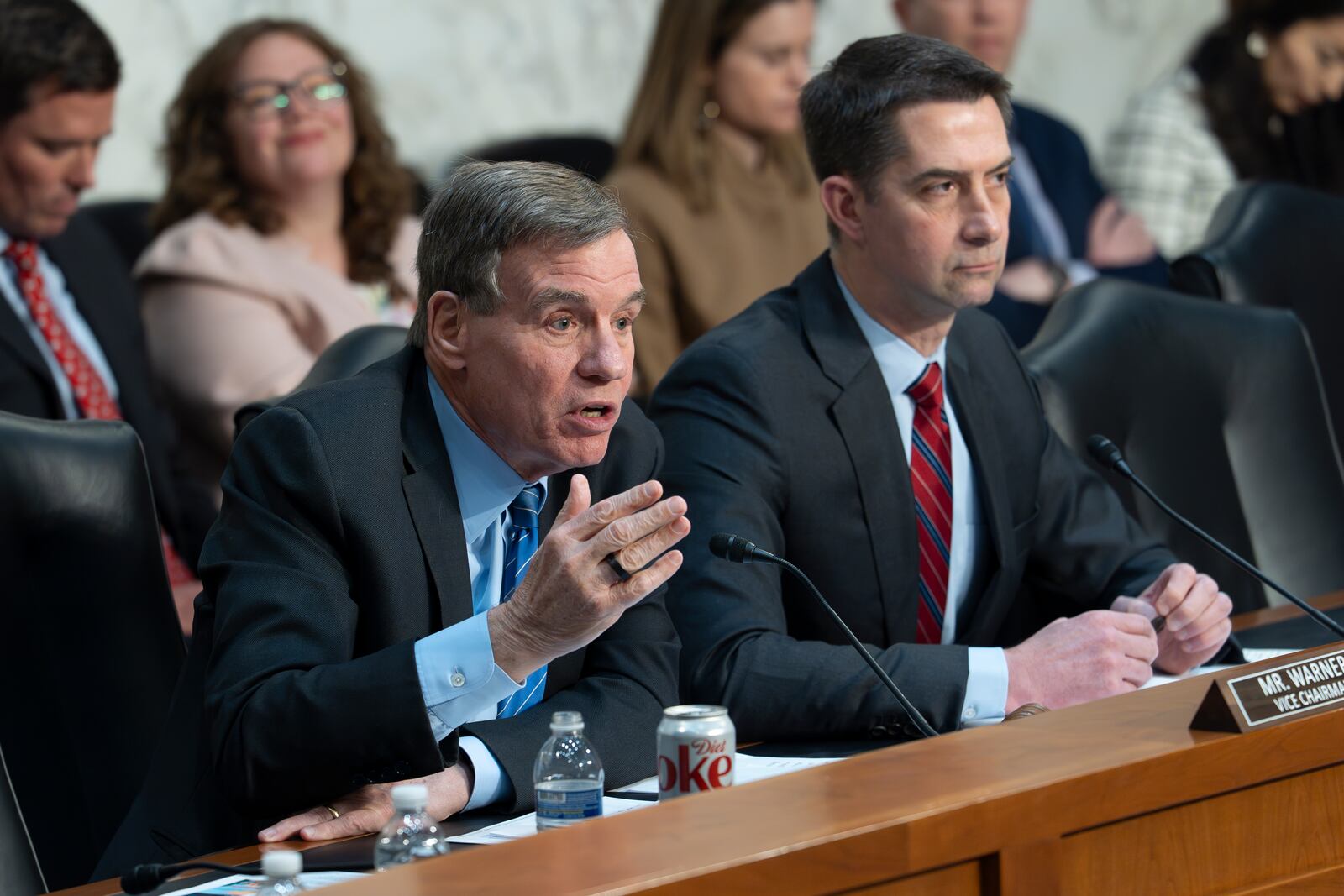 Sen. Mark Warner, D-Va., vice chair of the Senate Intelligence Committee, left, joined at right by Chairman Tom Cotton, R-Ark., questions Director of National Intelligence Tulsi Gabbard and CIA Director John Ratcliffe about texted war plans for upcoming military strikes in Yemen to a group chat that included the editor-in-chief for The Atlantic, at a hearing on Capitol Hill in Washington, Tuesday, March 25, 2025. (AP Photo/J. Scott Applewhite)