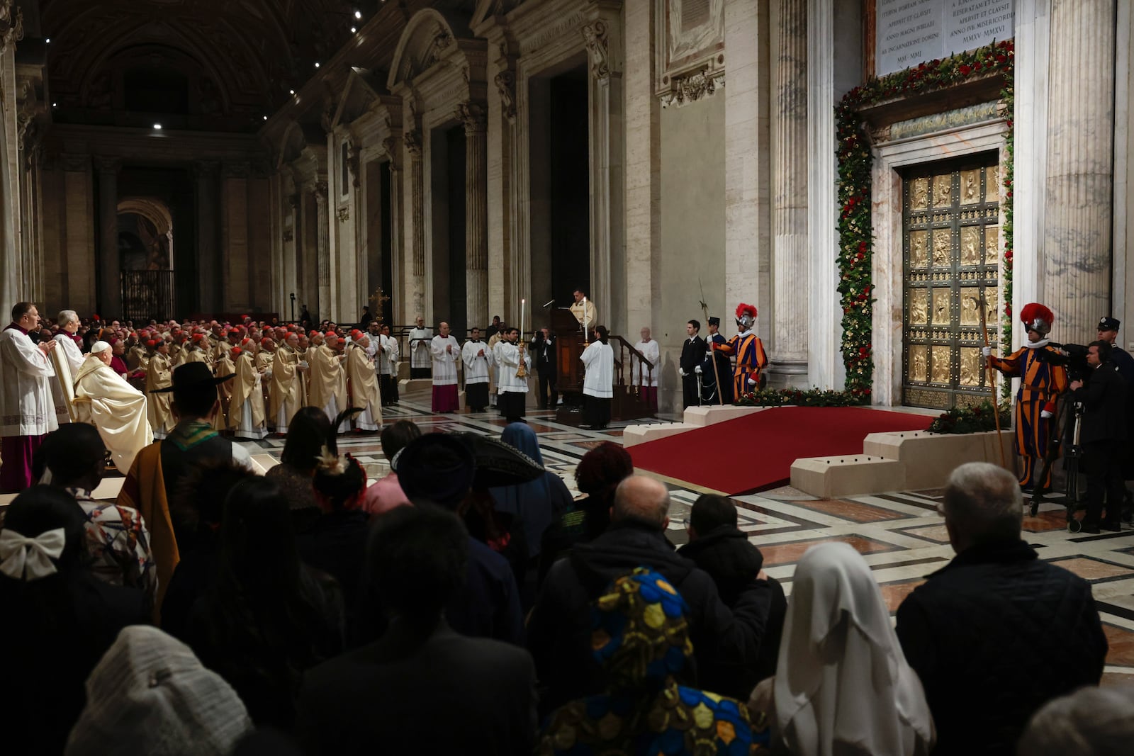 Pope Francis, third from left, celebrates a Christmas Eve Mass on the day the Pope opens the Holy Door to mark the opening of the 2025 Catholic Holy Year, or Jubilee, in St. Peter's Basilica, at the Vatican, Dec. 24, 2024. (Remo Casilli/Pool Photo via AP)