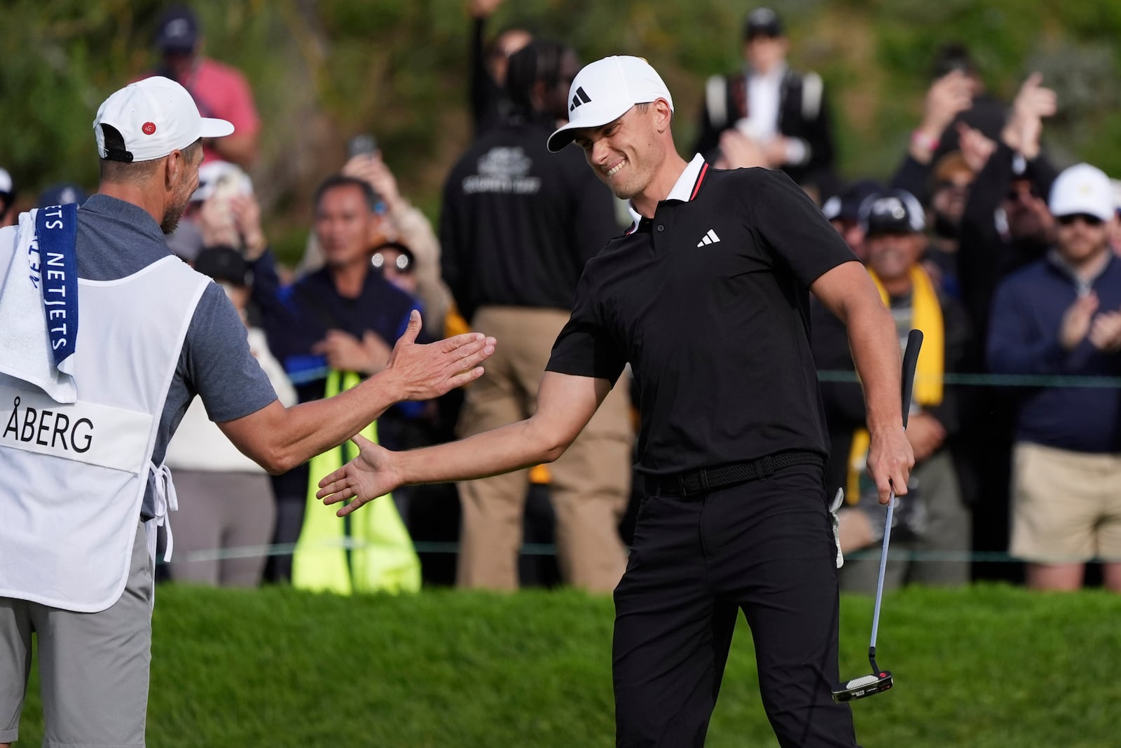 Ludvig Åberg, of Sweden, right, celebrates after winning the Genesis Invitational golf tournament Sunday, Feb. 16, 2025, in San Diego. (AP Photo/Gregory Bull)