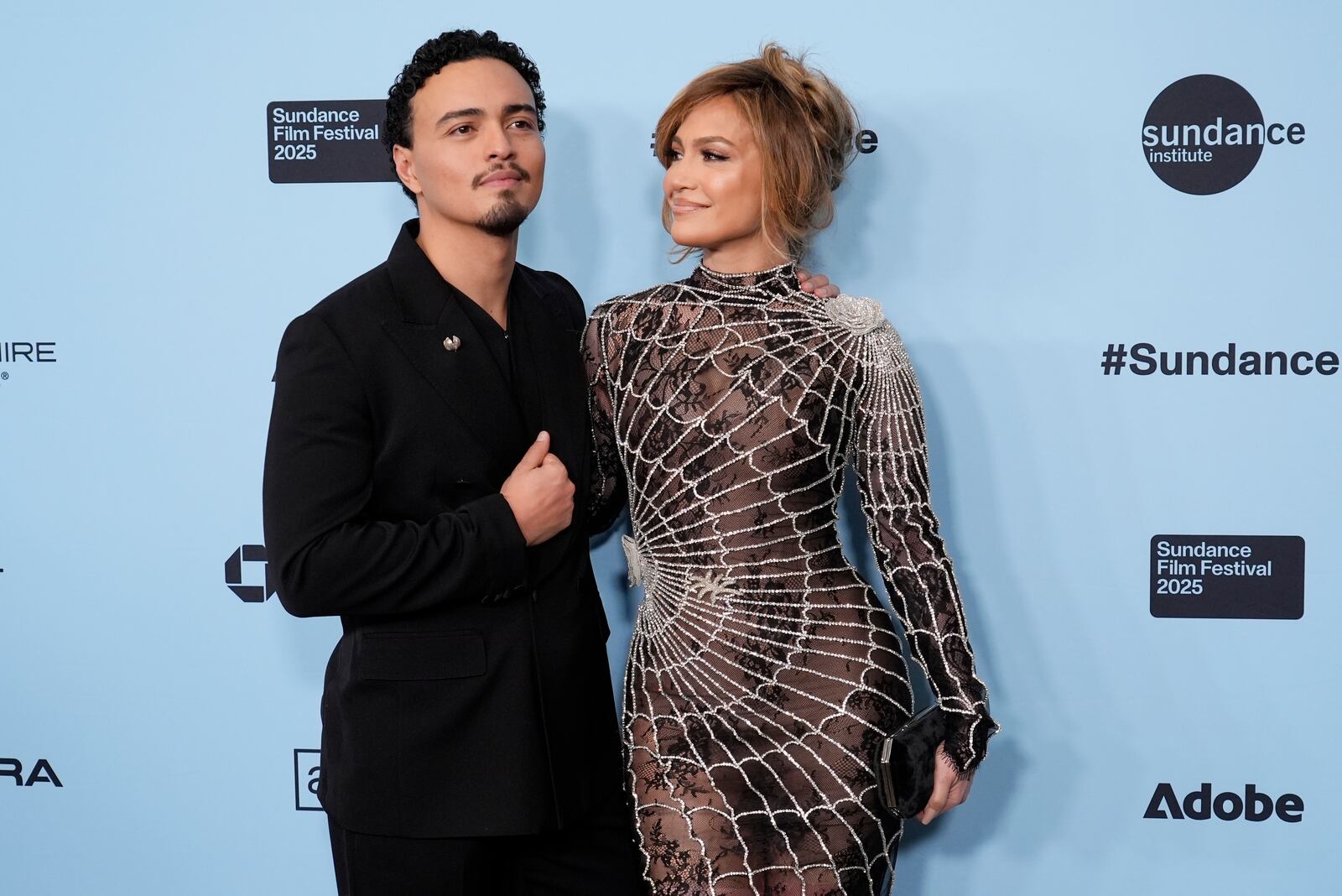 Jennifer Lopez, right, and Tonatiuh, cast members in "Kiss of the Spider Woman," pose together at the premiere of the film during the Sundance Film Festival on Sunday, Jan. 26, 2025, in Park City, Utah. (AP Photo/Chris Pizzello)