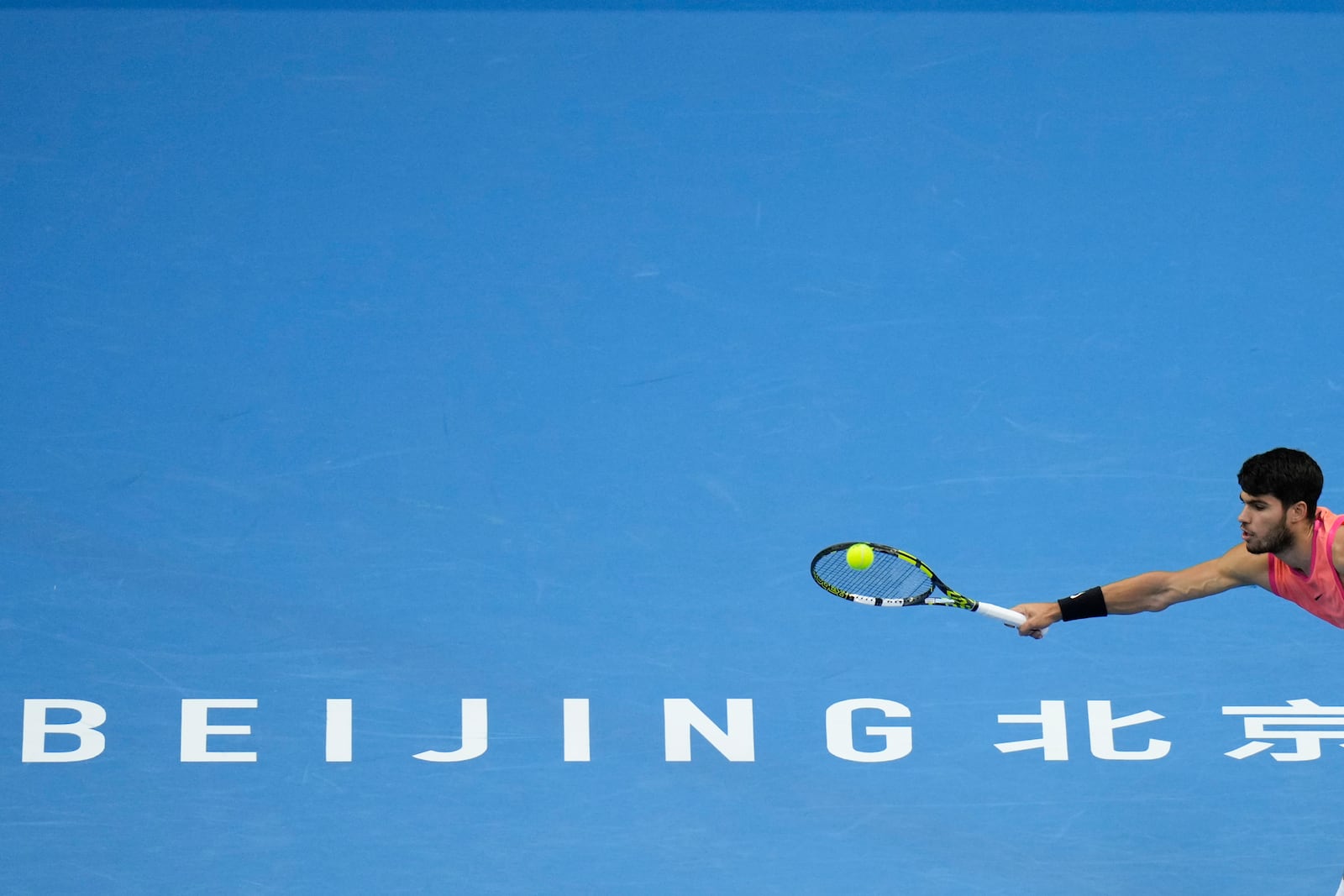 Carlos Alcaraz of Spain returns a shot from Jannik Sinner of Italy during their men's singles finals match of the China Open tennis tournament, at the National Tennis Center in Beijing, Wednesday, Oct. 2, 2024. (AP Photo/Andy Wong)