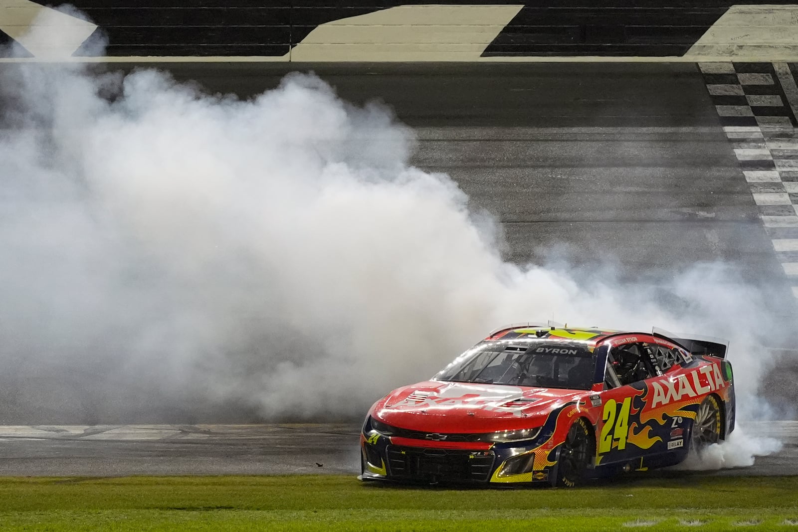 William Byron (24) does a burnout at the finish line after winning the NASCAR Daytona 500 auto race at Daytona International Speedway, Sunday, Feb. 16, 2025, in Daytona Beach, Fla. (AP Photo/John Raoux)