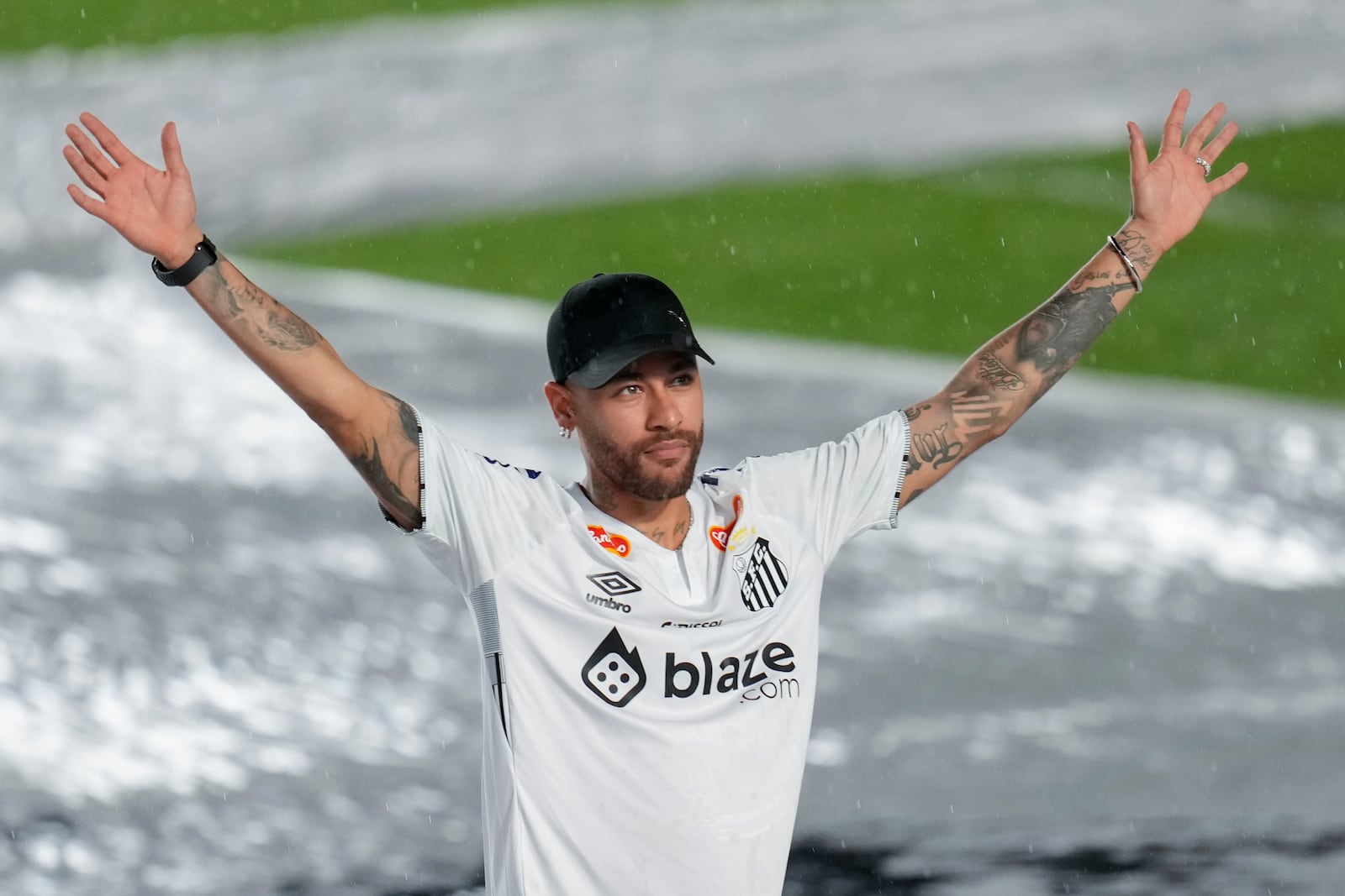 Brazilian soccer player Neymar waves to fans during his presentation ceremony after signing a six-month contract with Santos FC at Vila Belmiro Stadium in Santos, Brazil, Friday, Jan. 31, 2025. (AP Photo/Andre Penner)