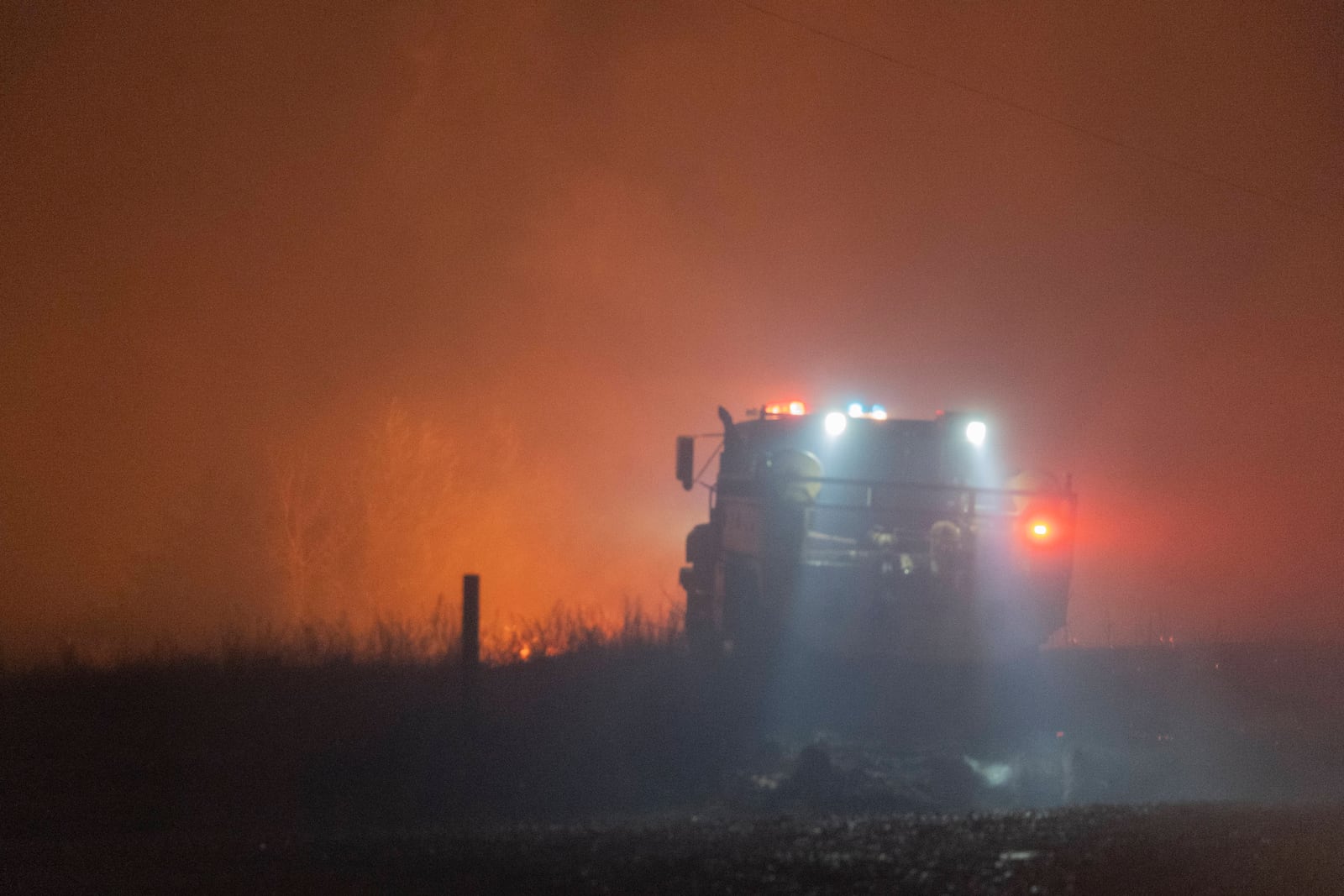 Fire crews battle a wildfire Friday, March 14, 2025, south of Langston, Okla. (AP Photo/Alonzo Adams)