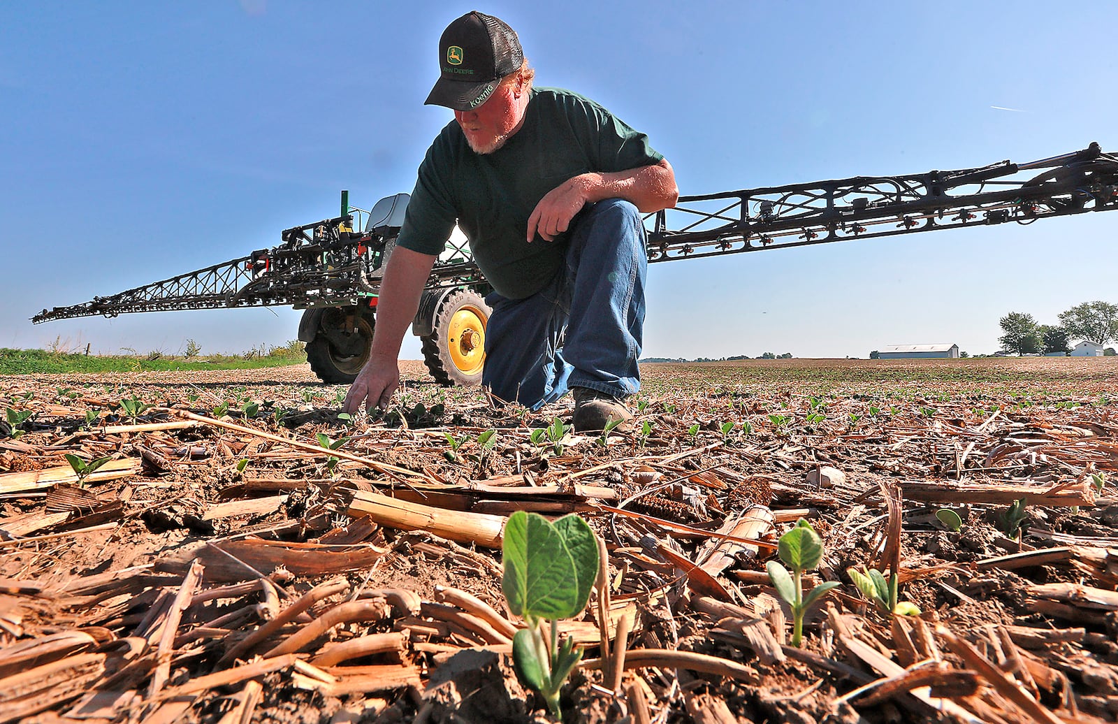 Clark County farmer Brian Harbage takes a break from spraying his bean field Friday, June 2, 2023 to check out how the plants are doing. BILL LACKEY/STAFF