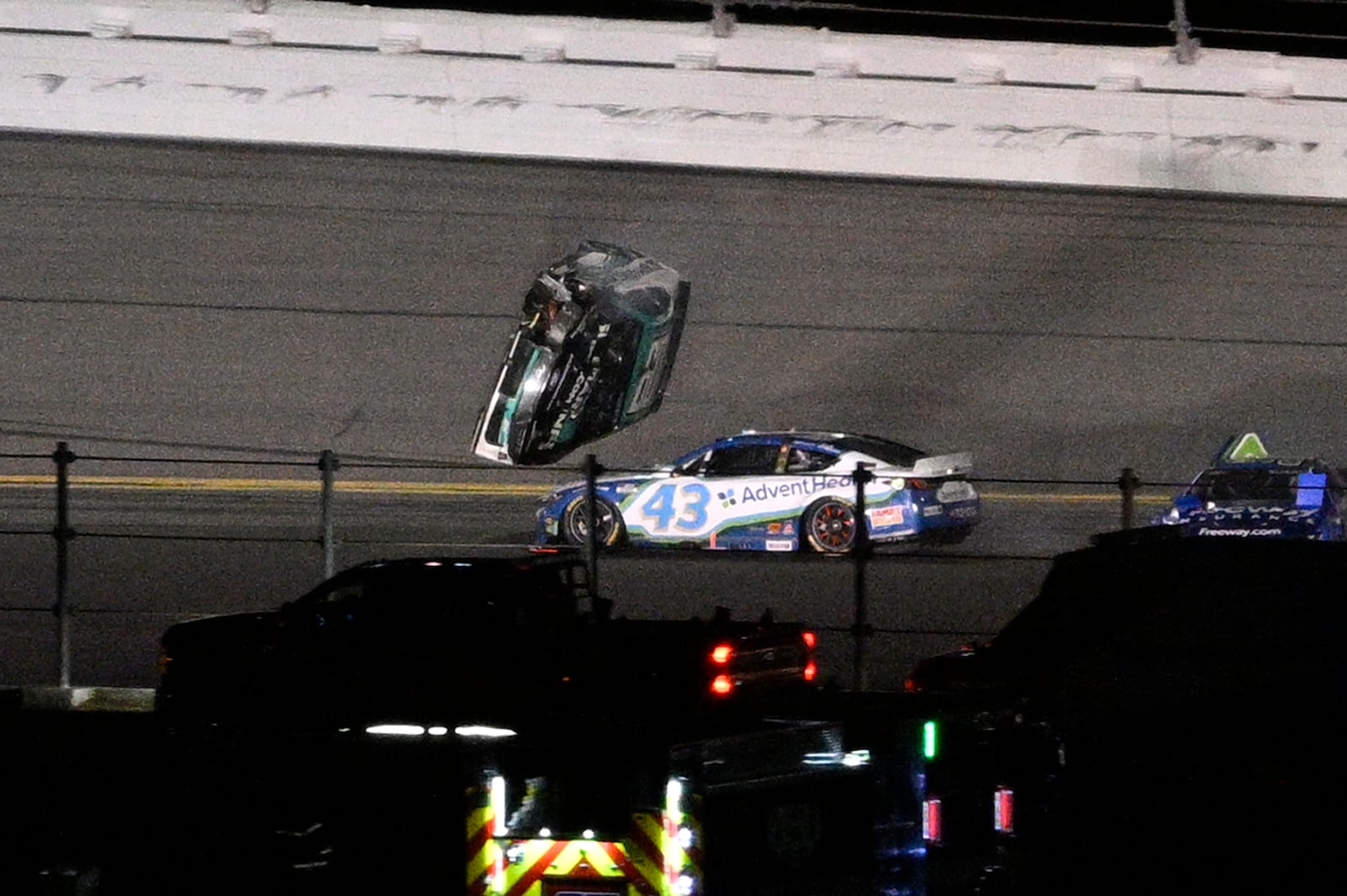 Ryan Preece's car goes airborne in Turn 3 after colliding with Erik Jones (43) during the NASCAR Daytona 500 auto race at Daytona International Speedway, Sunday, Feb. 16, 2025, in Daytona Beach, Fla. (AP Photo/Phelan M. Ebenhack)