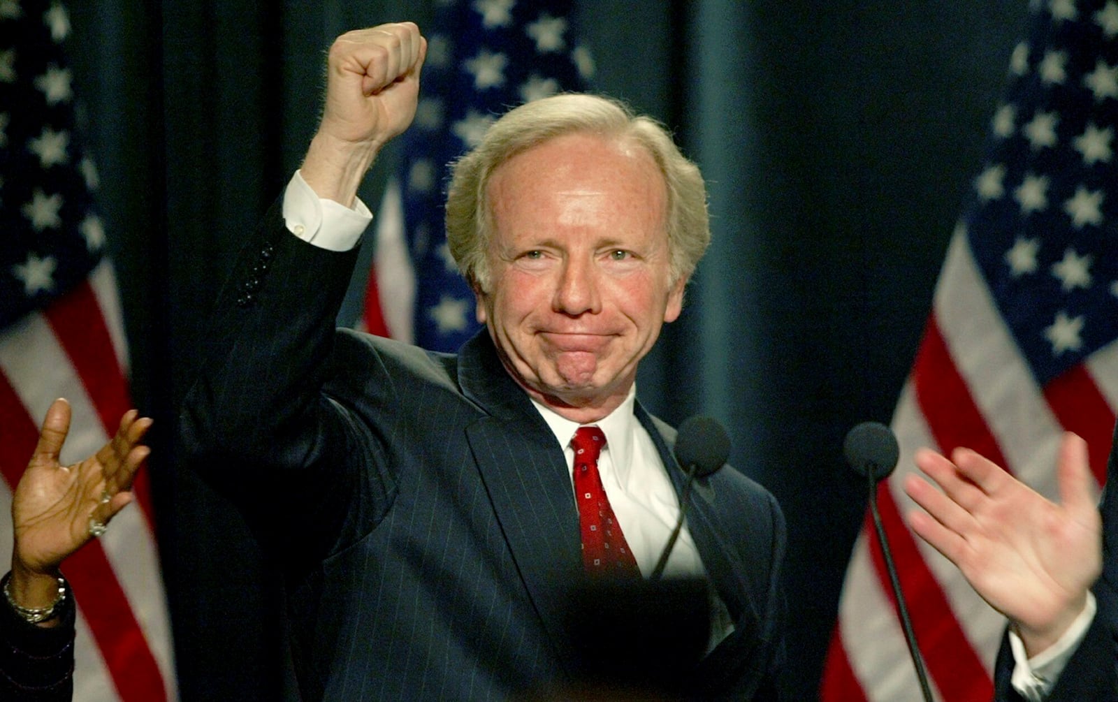 FILE - Democratic presidential hopeful Sen. Joe Lieberman, D-Conn., raises his fist after finishing his speech to the Democratic National Committee in Washington, Feb. 21. 2003. (AP Photo/Charles Dharapak, File)