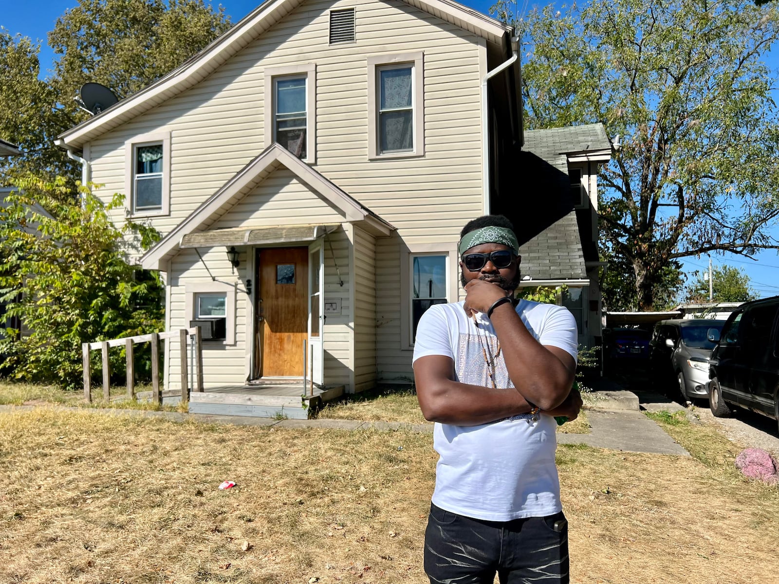 Venel Scylla outside the home he rents on Shaffer Street in Springfield in September 2024. Scylla, a Haitian immigrant, said he works at a bakery and has lived in Springfield for a year. The home is owned by Ten Enterprises, connected to George Ten of First Diversity Staffing. AIMEE HANCOCK / STAFF