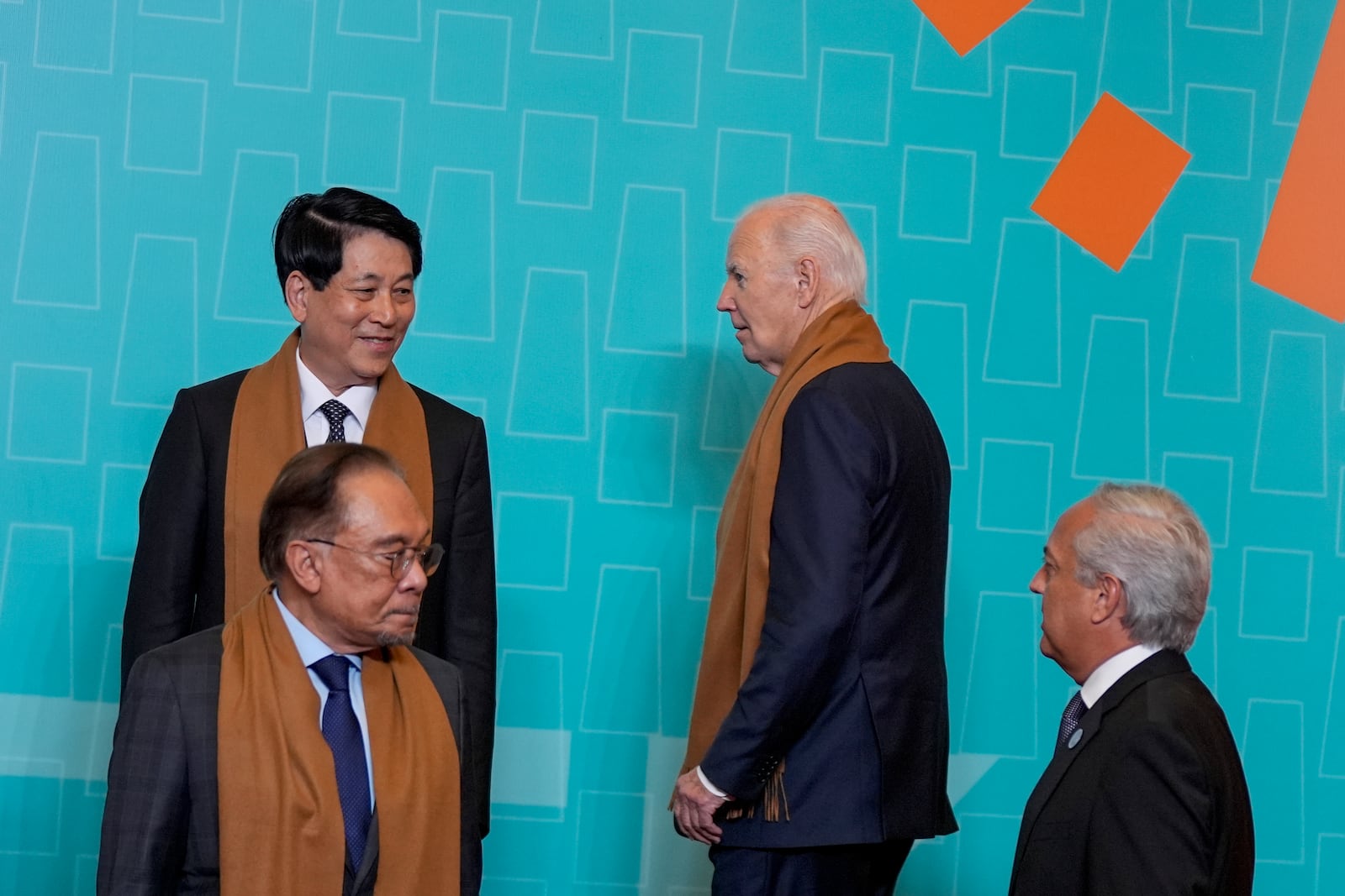 President Joe Biden arrives next to Vietnam's President Luong Cuong, left, and Malaysia's Prime Minster Anwar Ibrahim, below-left, as they gather with other APEC leaders for a family photograph at the APEC Summit in Lima, Peru on Saturday, Nov. 16, 2024. (AP Photo/Manuel Balce Ceneta)