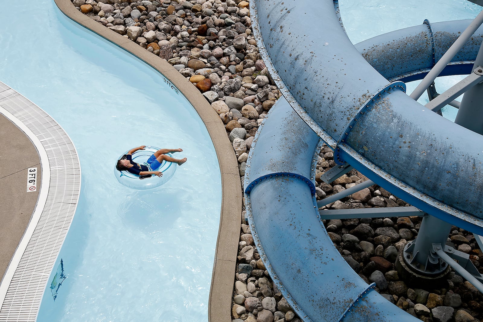 A swimmer floats along the Lazy River at Splash Zone water park Tuesday, June 18, 2024. BILL LACKEY/STAFF