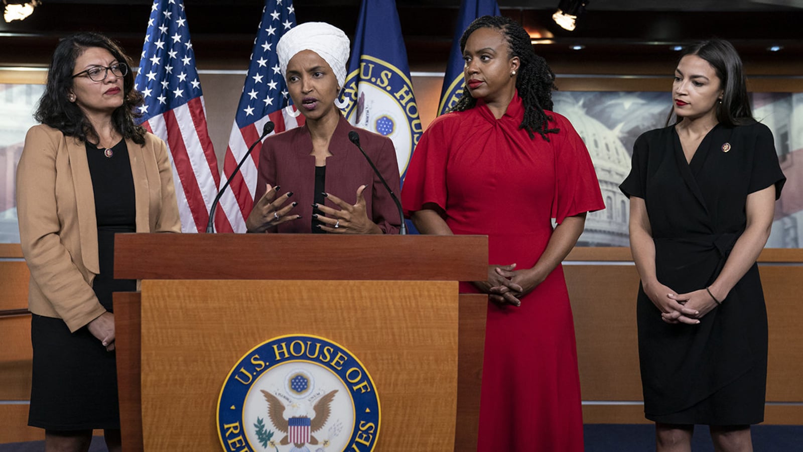 In this Monday, July 15, 2019, file photo, U.S. Rep. Ilhan Omar, D-Minn, speaks, as U.S. Reps., from left, Rashida Tlaib, D-Mich.,Ayanna Pressley, D-Mass., and Alexandria Ocasio-Cortez, D-N.Y., listen, during a news conference in Washington.